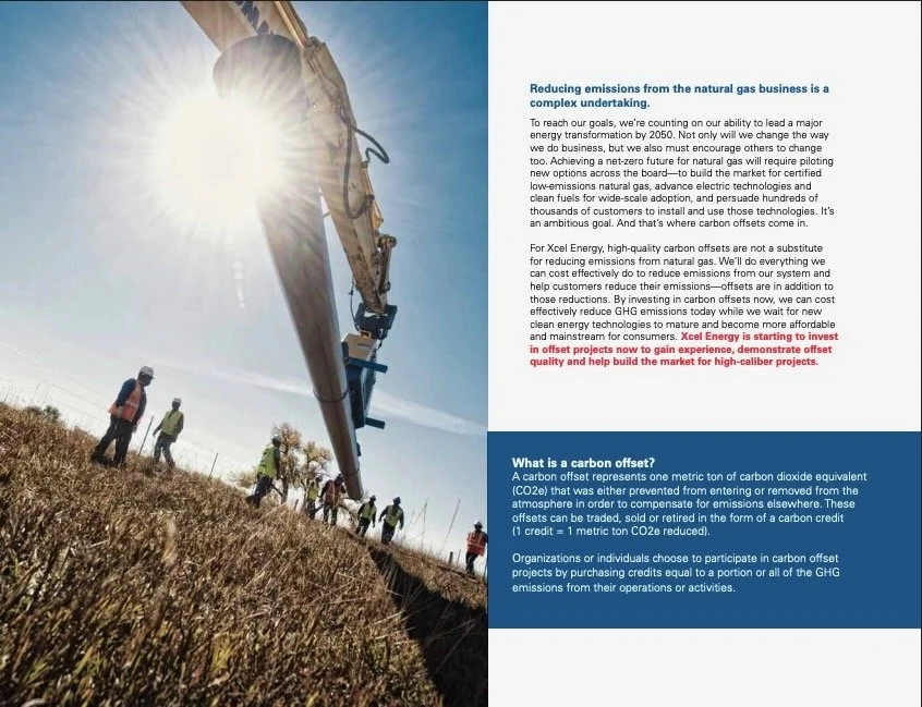 An aerial view of workers and a construction excavator at a work site, with bright sunlight in the background.