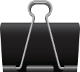 Close-up of a black binder clip on a dark background