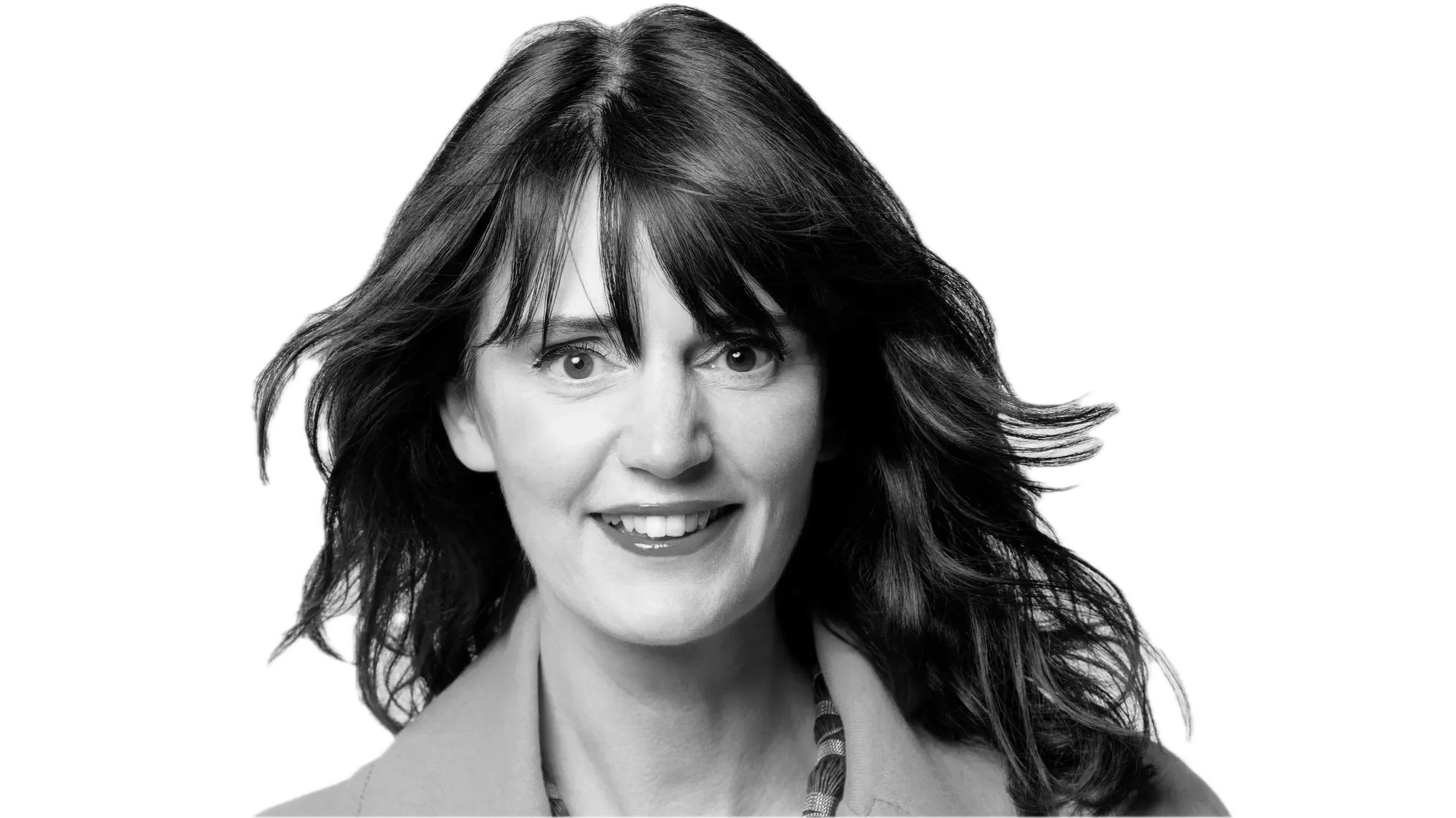 Black and white portrait of a woman with shoulder-length hair, smiling with visible teeth, in front of a black background.