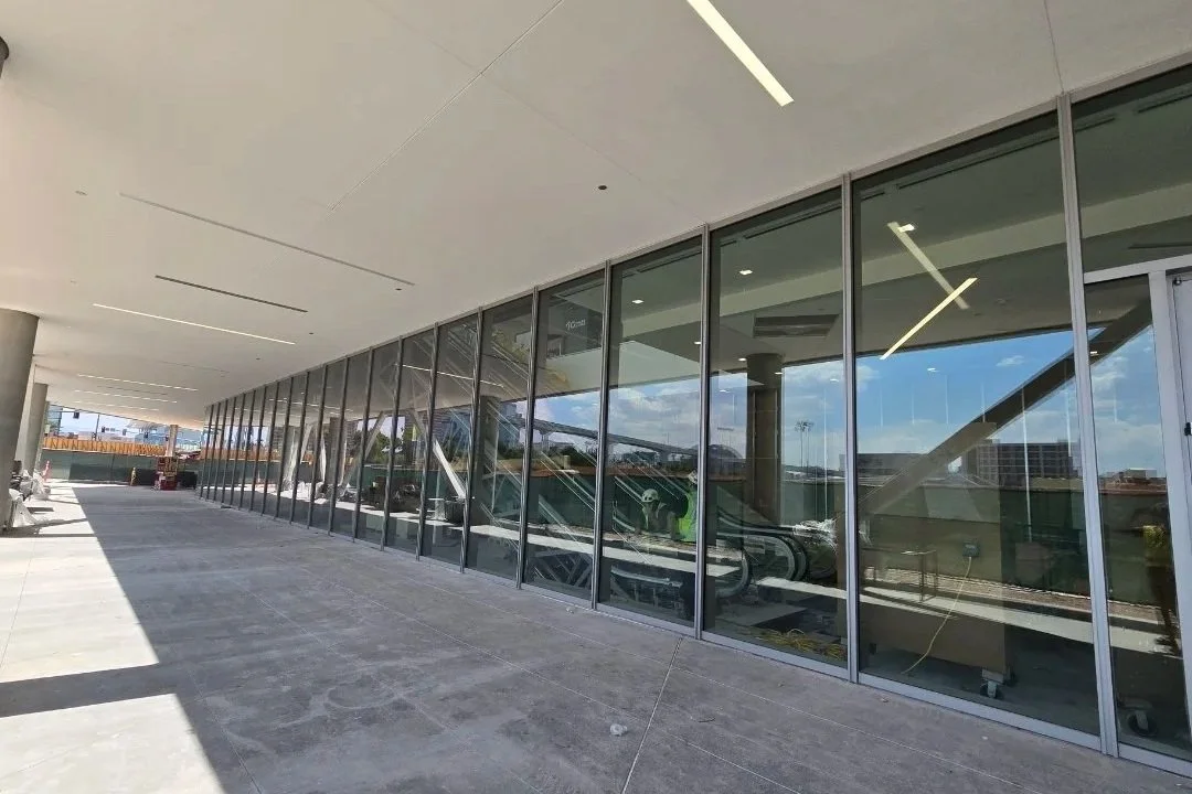 Exterior view of a modern building with large glass windows, expertly sealed by Hammond Caulking.