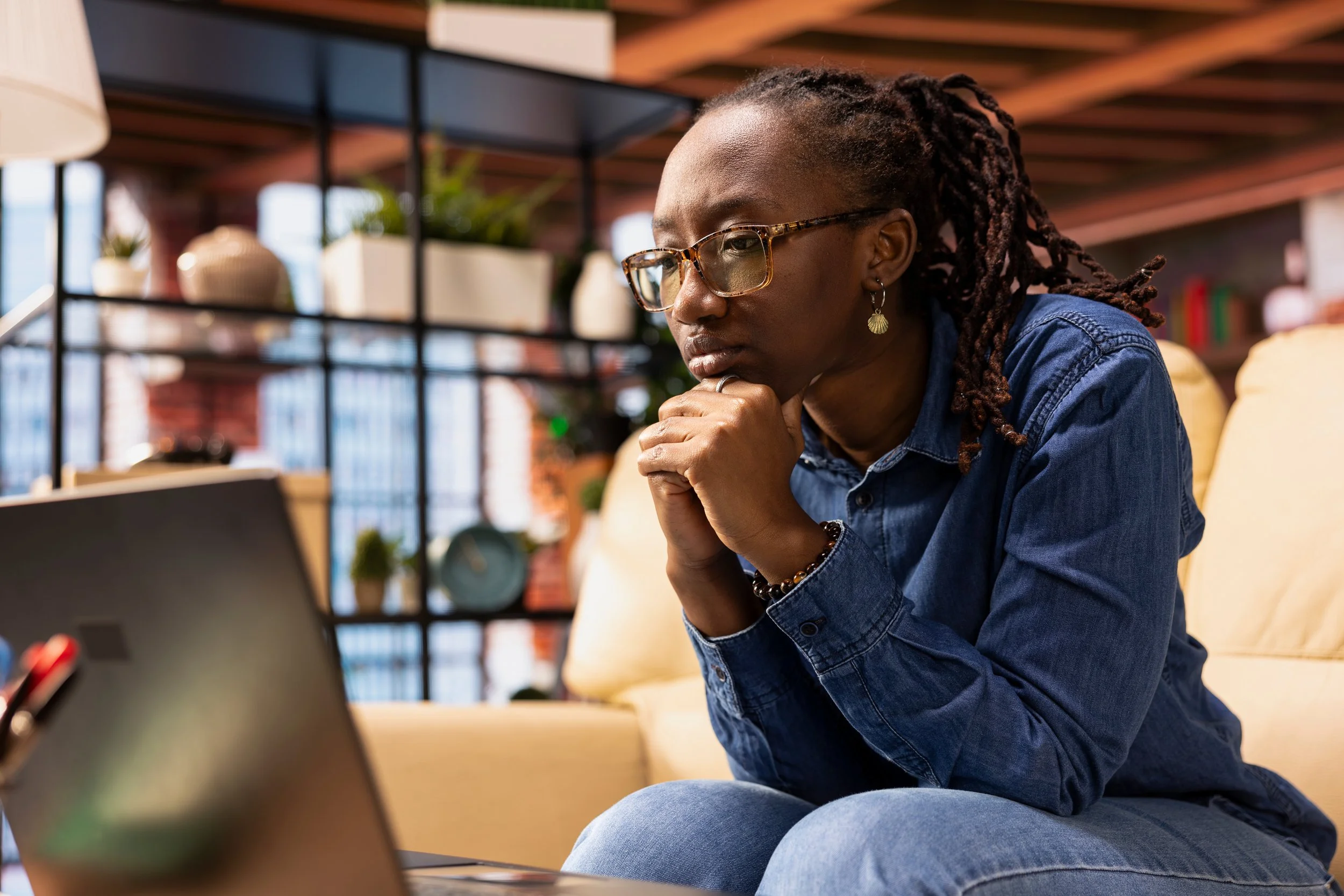 A Black woman with deadlocks getting therapy from Dr. Dana Crawford, top clinical psychologist. Black woman psychologist in New York City