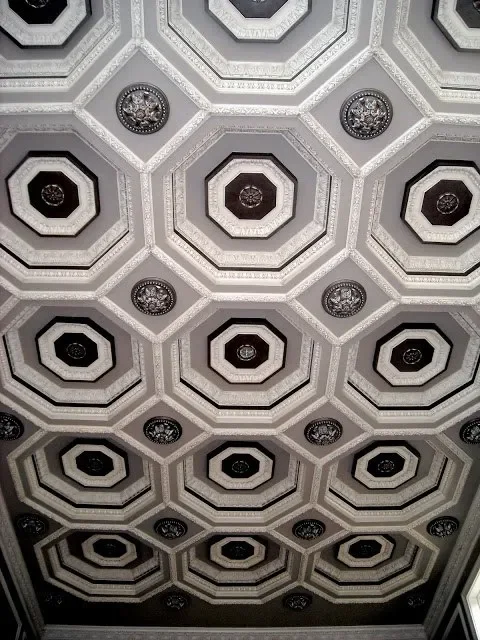 Ceiling with geometric octagonal patterns and decorative medallions.