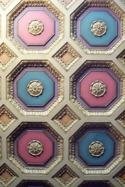 Ceiling with colorful octagonal and square decorative borders, featuring floral details.