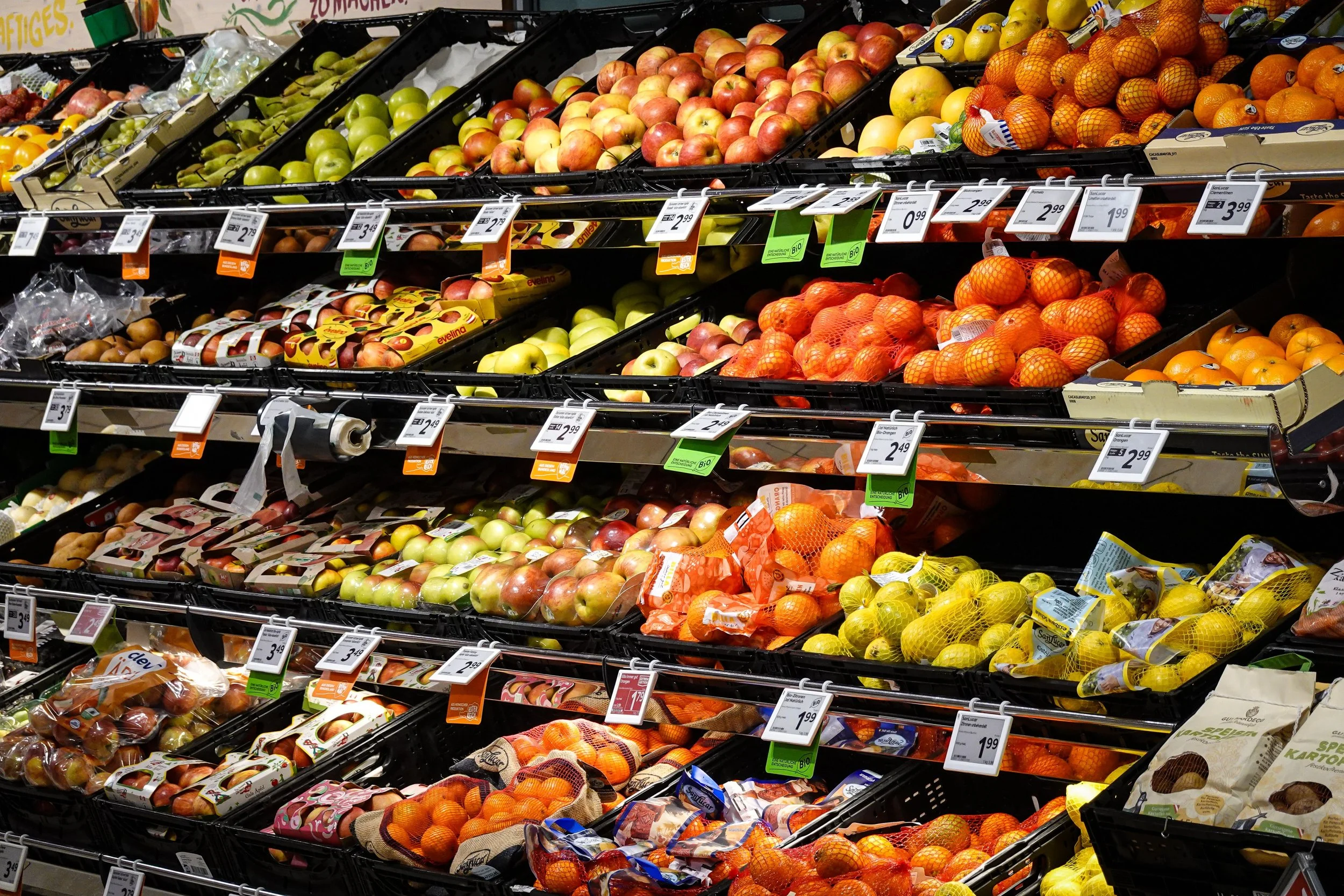 Organic and sustainably labeled food products on a German supermarket shelf, representing sustainability requirements for suppliers in the DACH food retail market