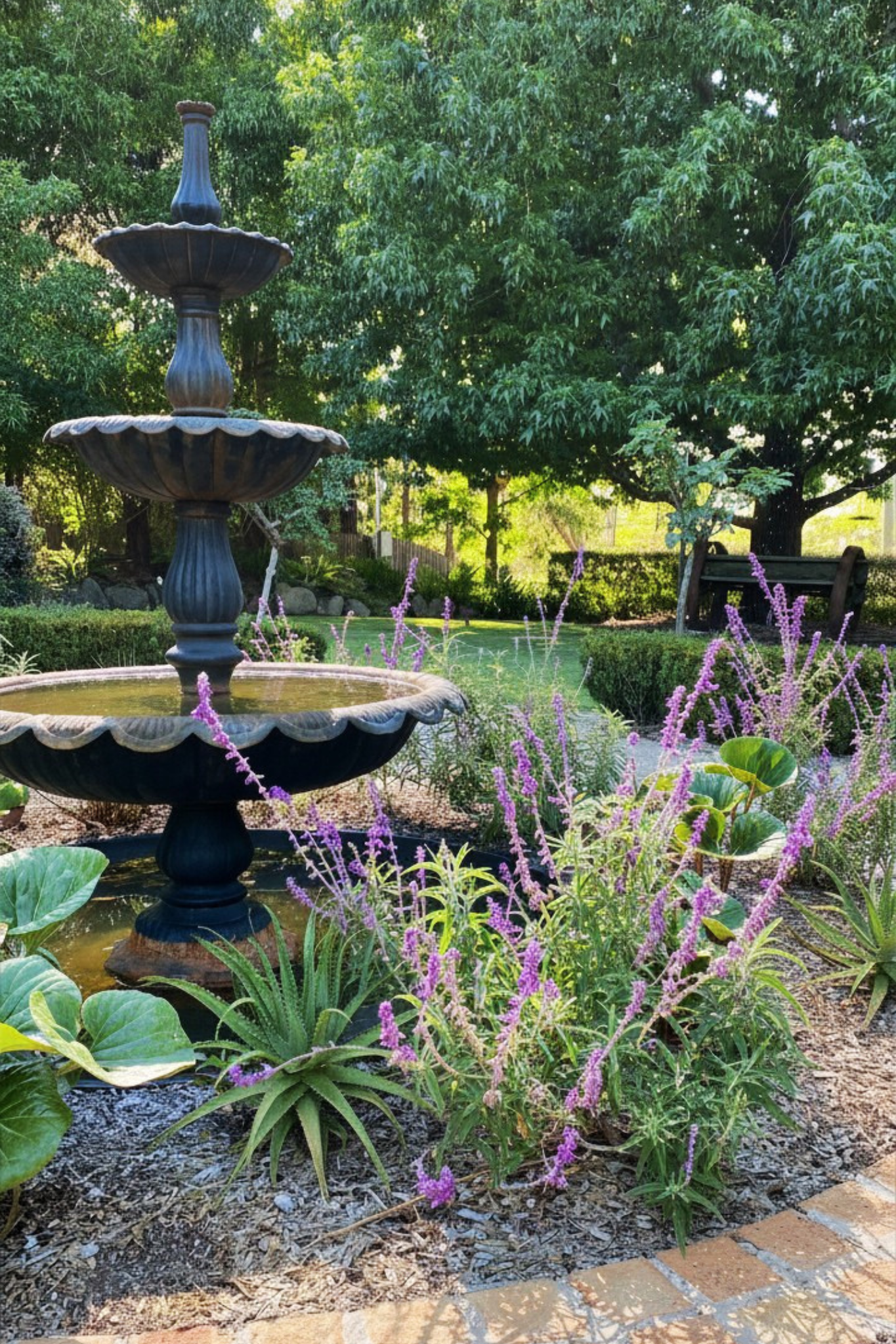 Fountain with bridge edging and mixed planting