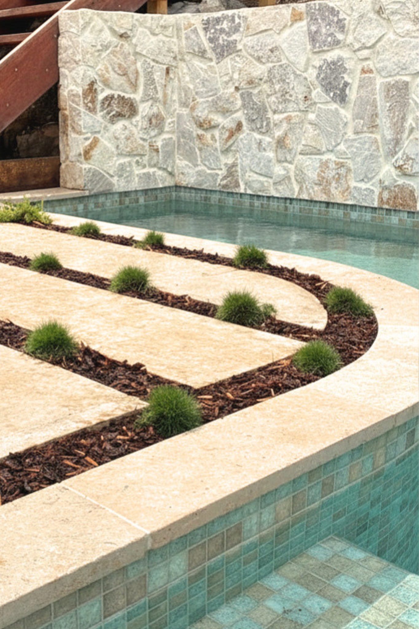 Curved poolside courtyard with integrated grasses