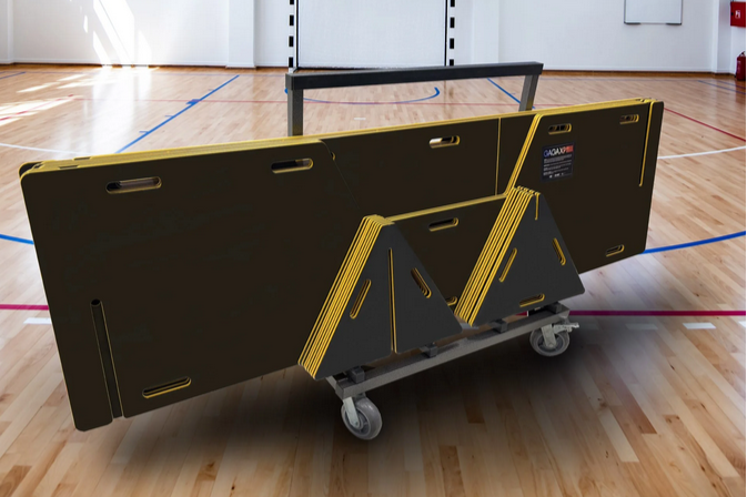 Black portable GagaXP panel on a wheeled platform in an indoor gym with a wooden floor.