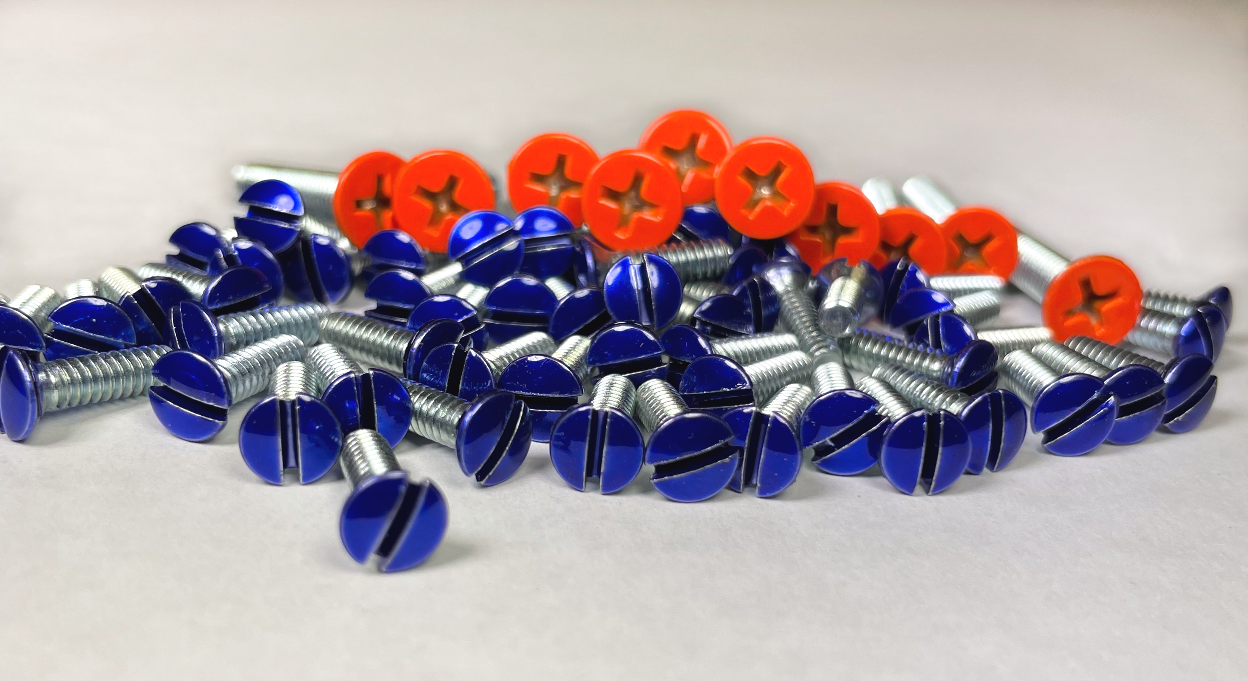 Blue powder coated flat head screws and orange powder coated Phillips head screws