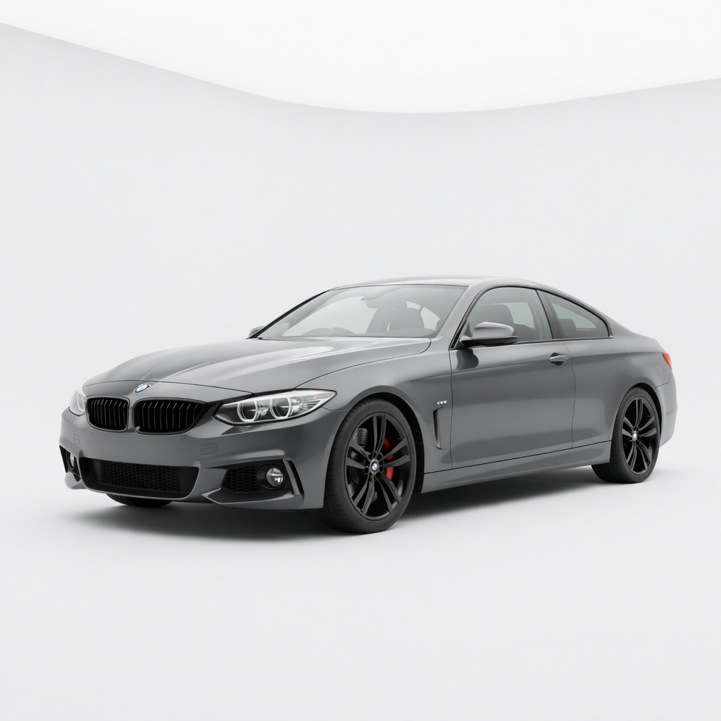 A sleek, gray BMW coupe parked in a minimalistic white studio.
