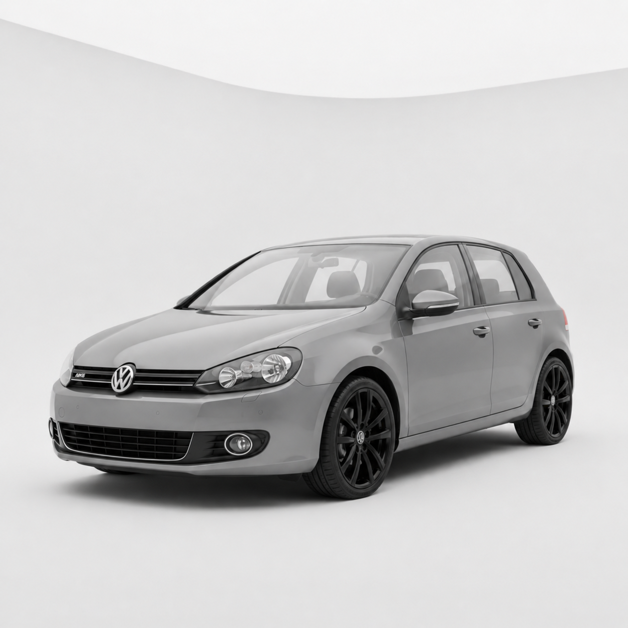 A silver Volkswagen hatchback with black rims on a plain white background.
