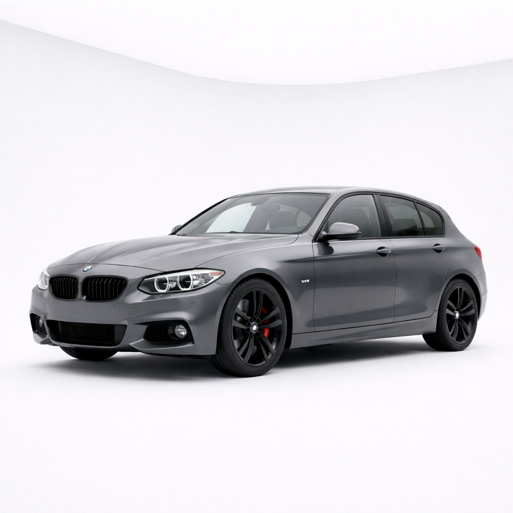 A gray BMW sedan parked in a white studio with black wheels and red brake calipers.