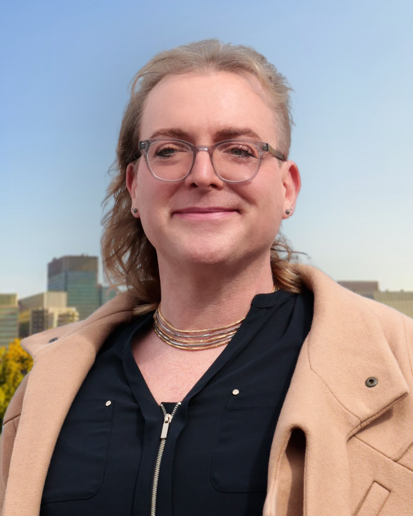 Clinton Karr, founder and CMO, ProGEO.ai, smiling outdoors with a cityscape and blue sky in the background.