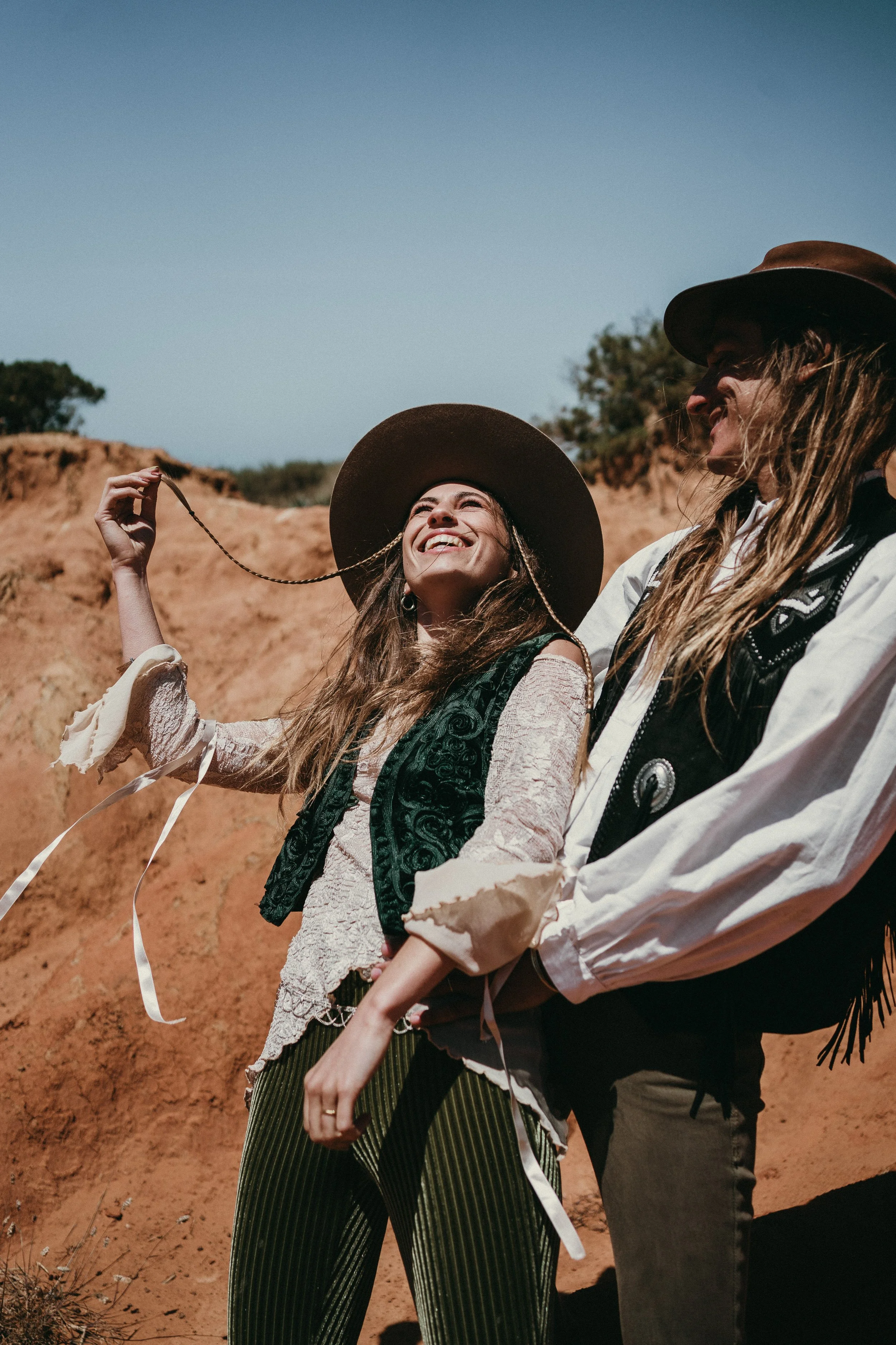 Adventure elopement in Portugal with boho couple on coastal cliffs at sunset