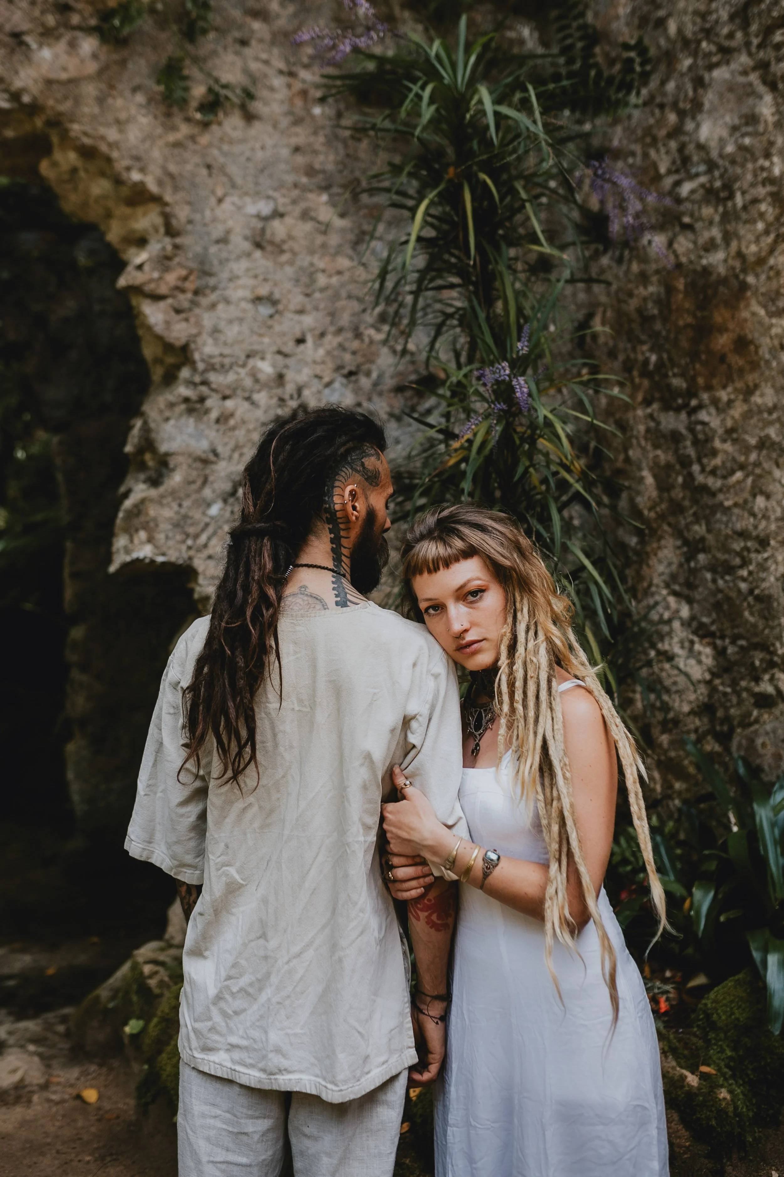 Engagement photography in Sintra forest, couple embracing among lush greenery during outdoor session in Portug