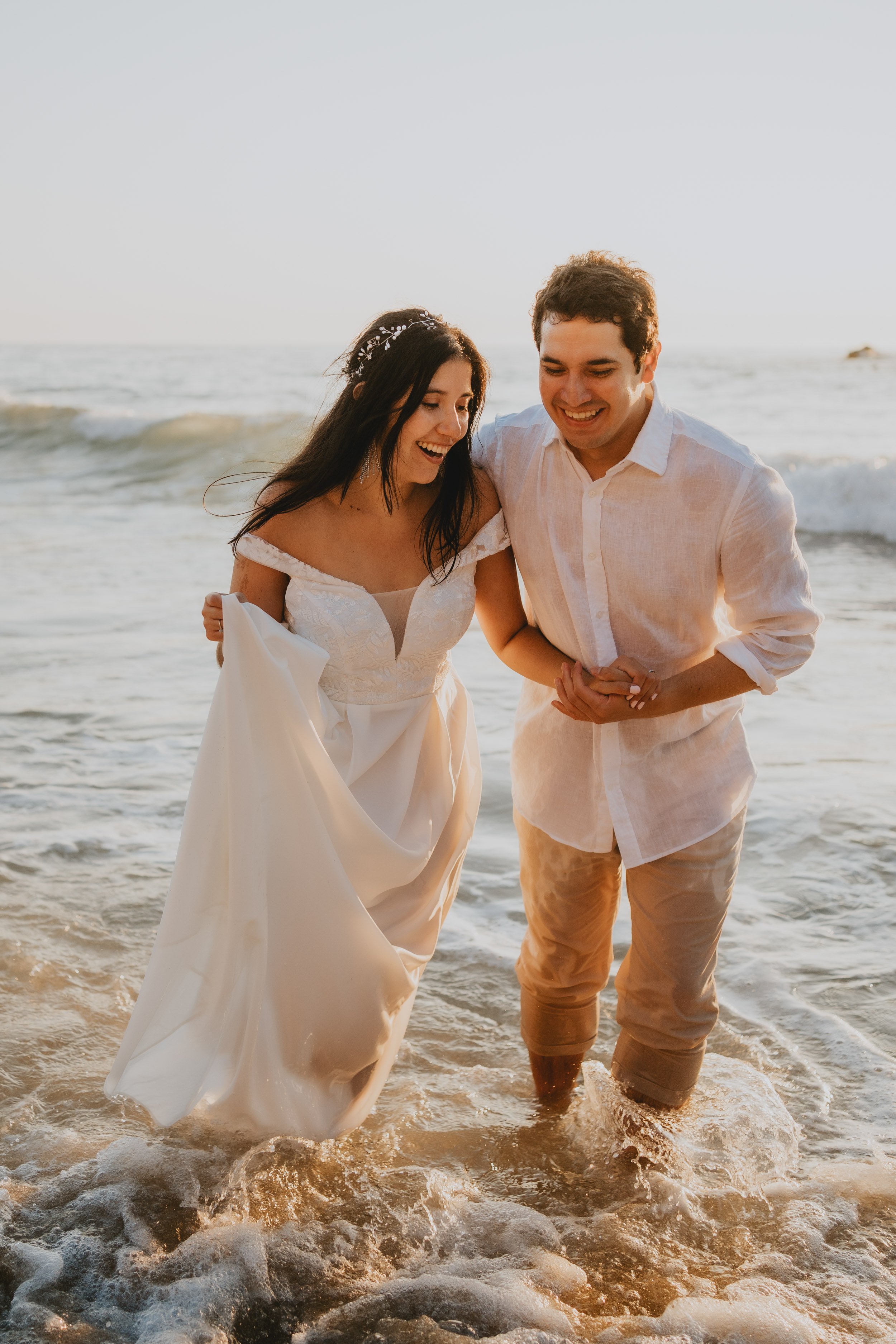 Couple holding each other at Praia da Adraga during golden hour elopement in Sintra