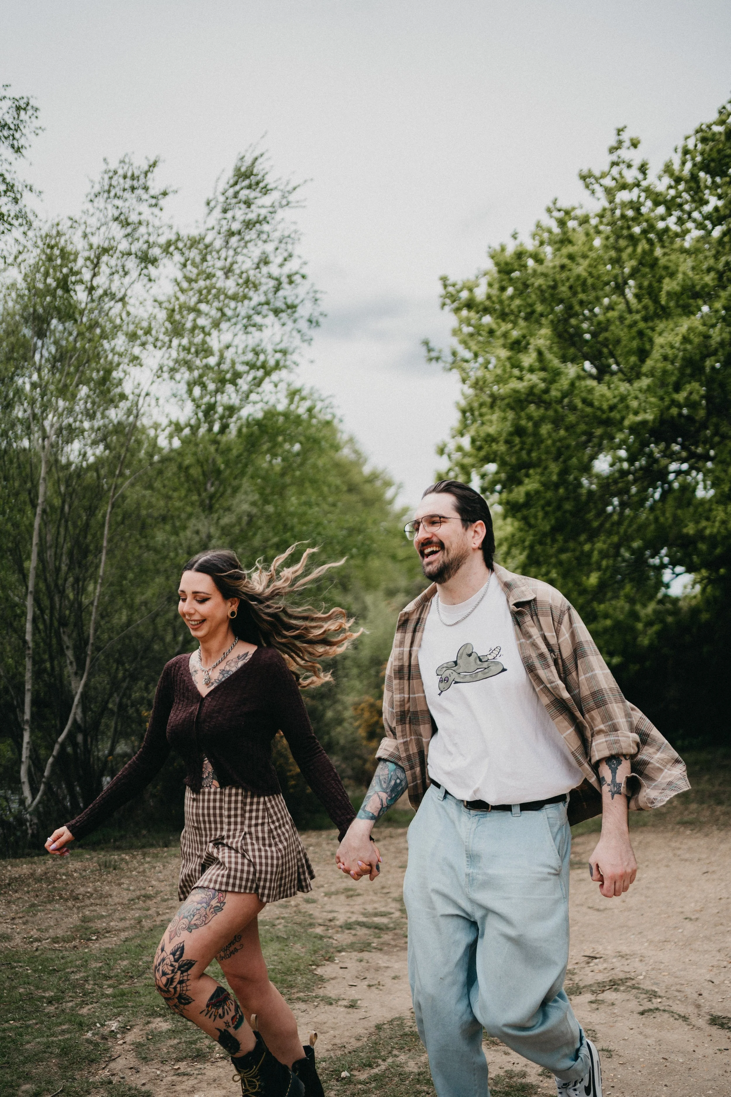 Engagement photography in London, couple running outdoors.