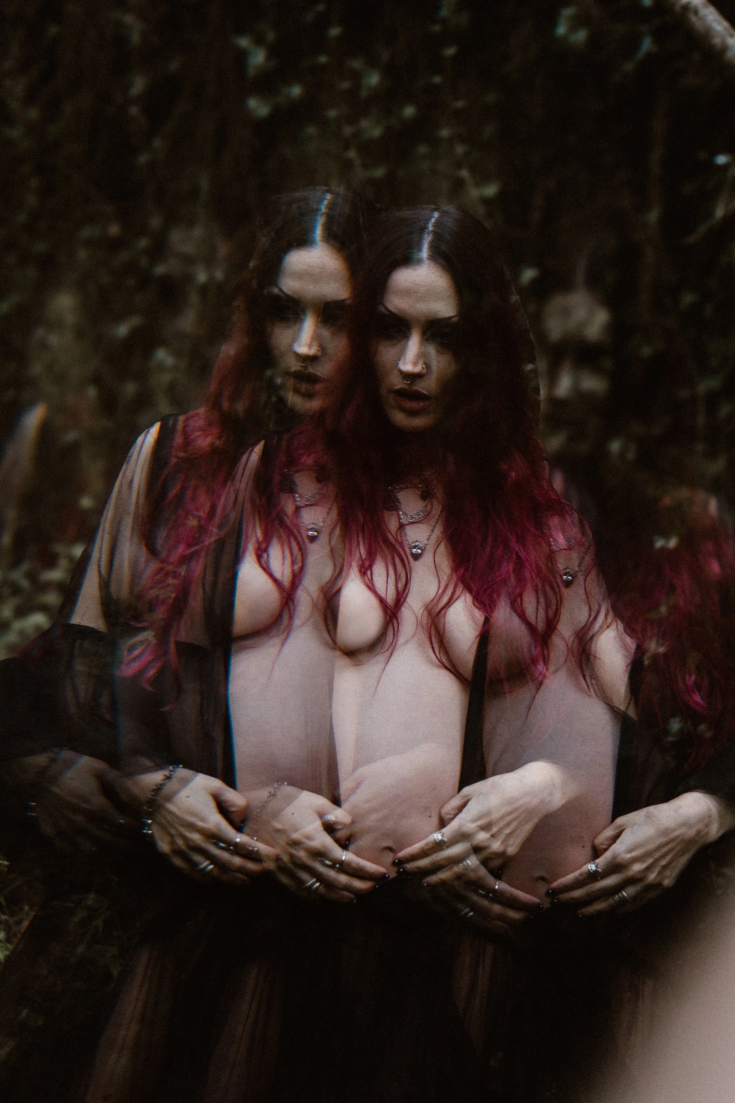 Artistic outdoor maternity photoshoot in nature featuring a pregnant woman in dramatic styling in Portugal.