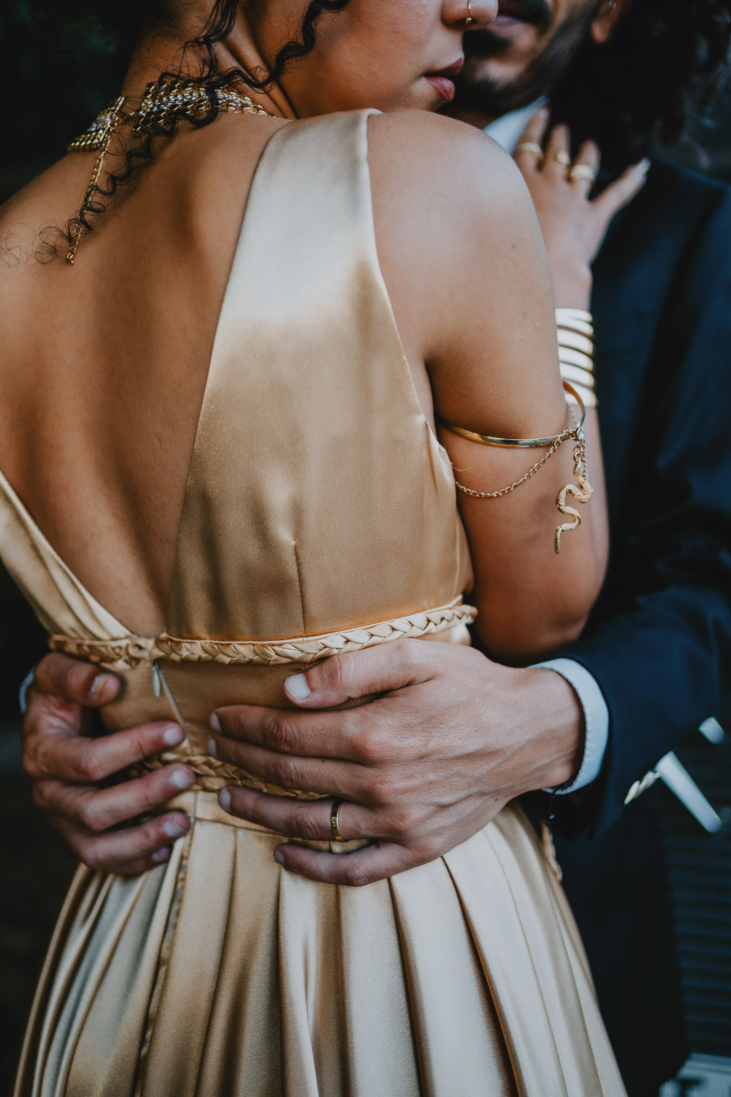Close-up bridal detail capturing texture of wedding dress and intimate moment