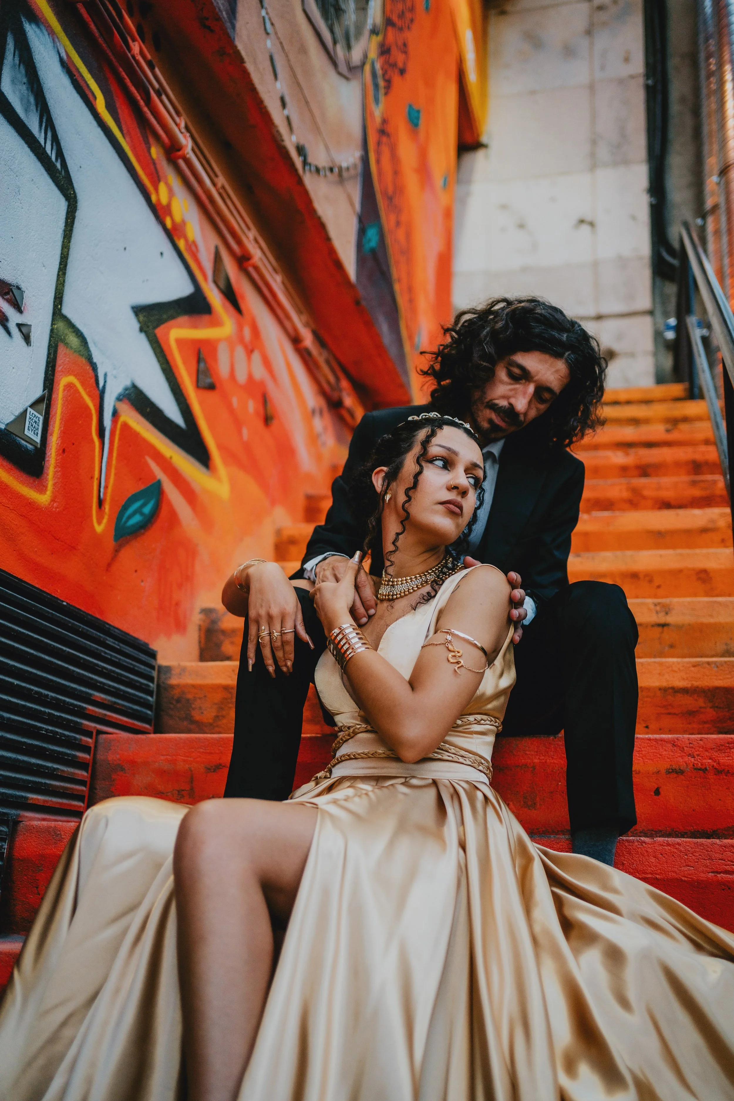 Modern alternative bride portrait against vibrant urban mural during Portugal wedding
