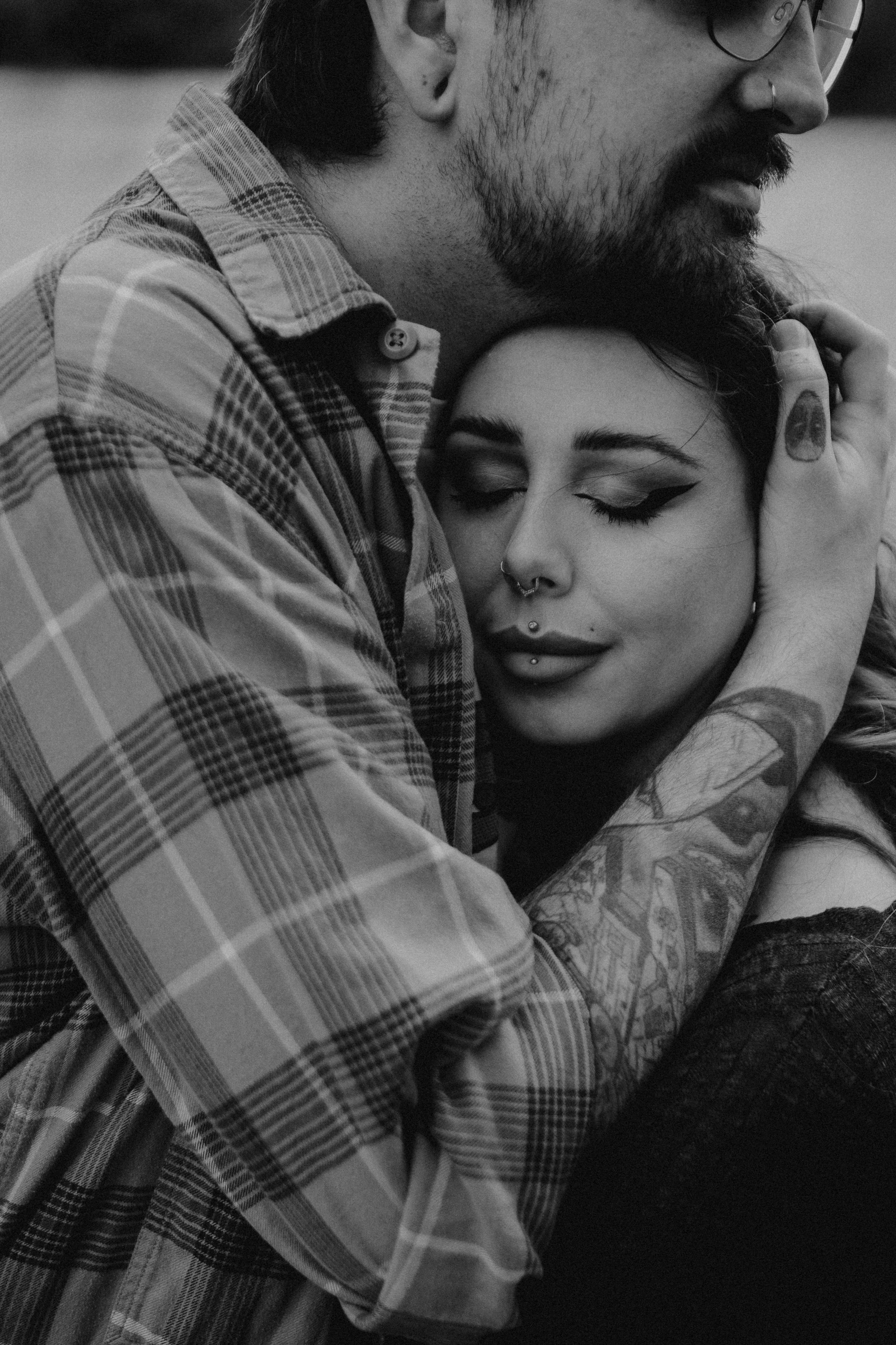 Black and white engagement photography portrait of couple in intimate embrace.