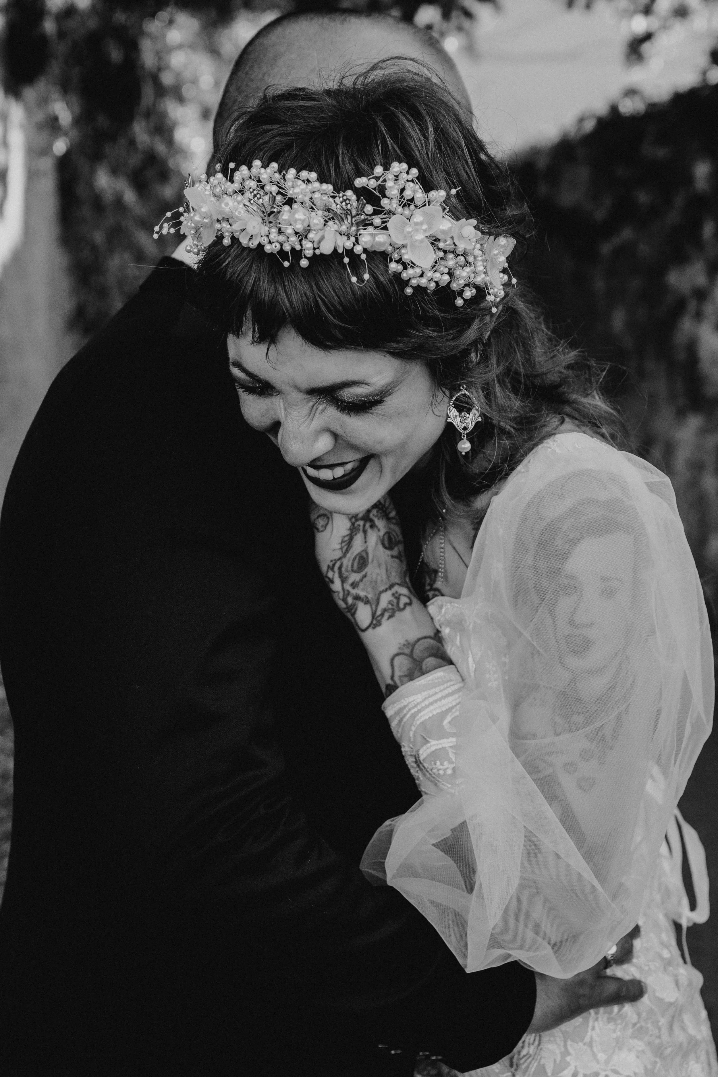 Intimate black and white wedding portrait capturing tender moment between bride and groom