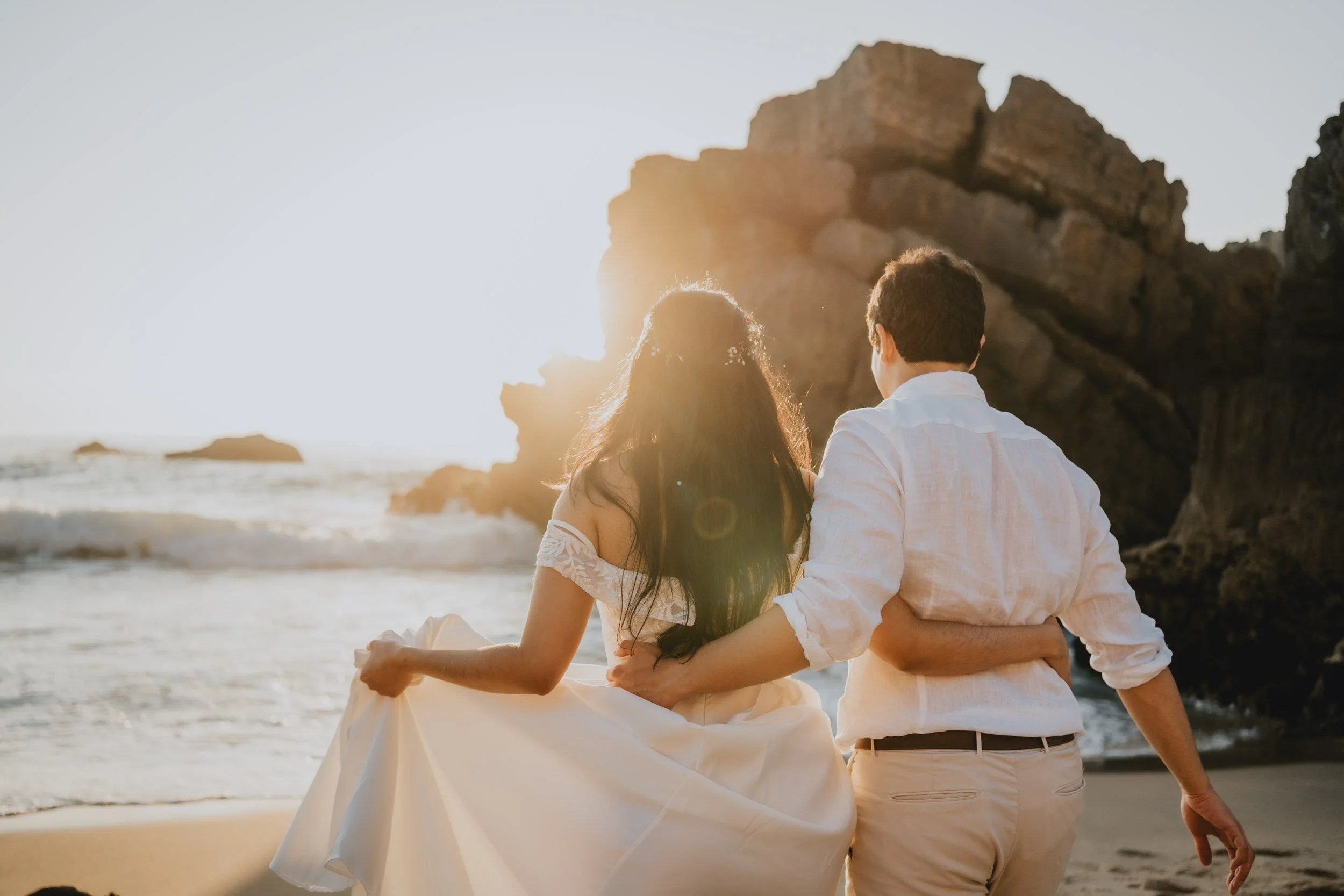 Bride and groom embracing at Praia da Adraga during their coastal elopement in Sintra, Portugal