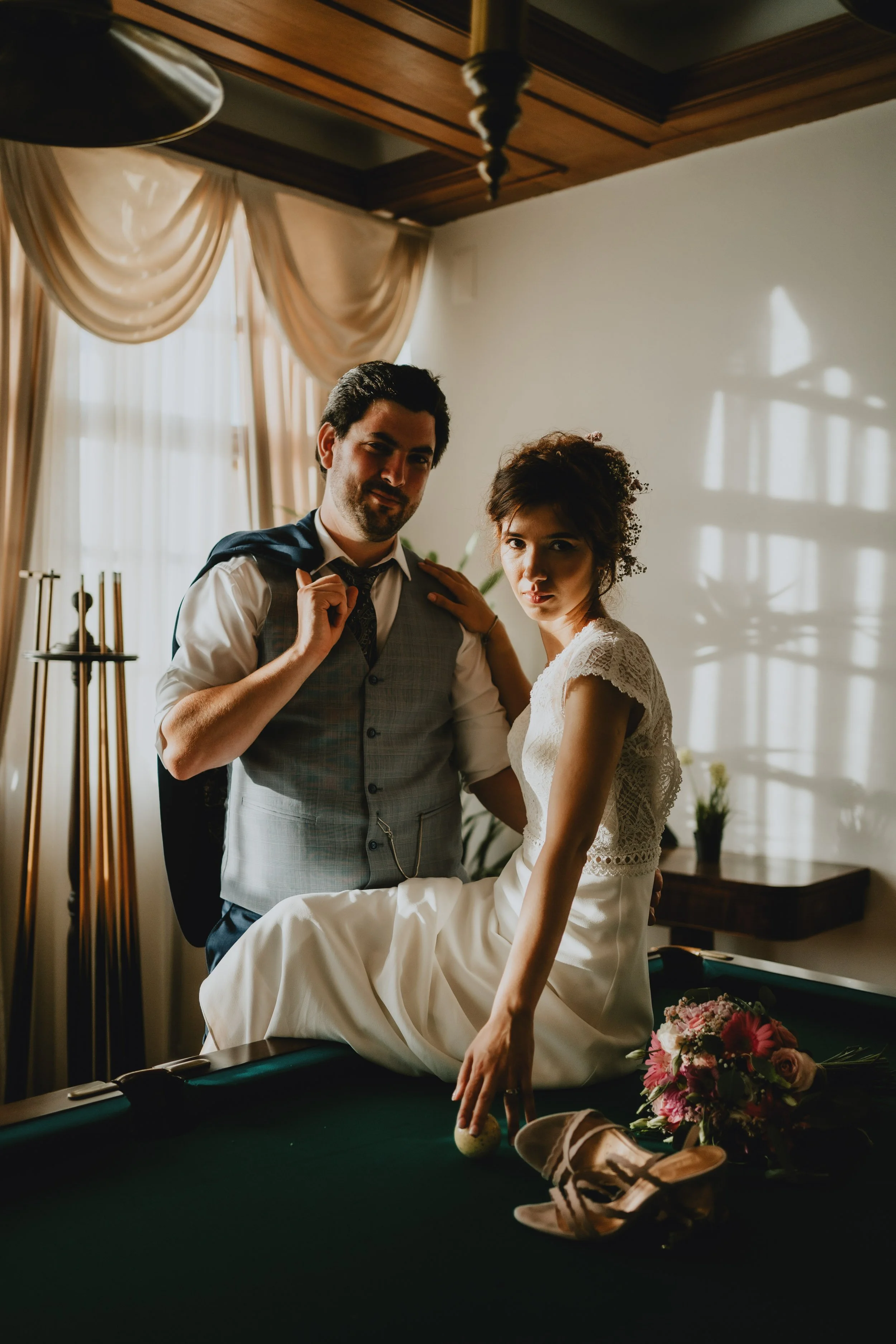 Portrait of bride and groom in a pool table