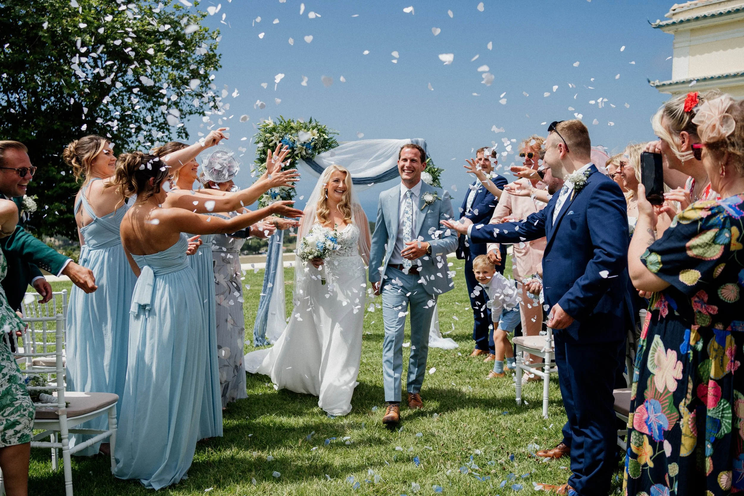 Joyful wedding confetti toss during an outdoor ceremony in Sintra with guests celebrating