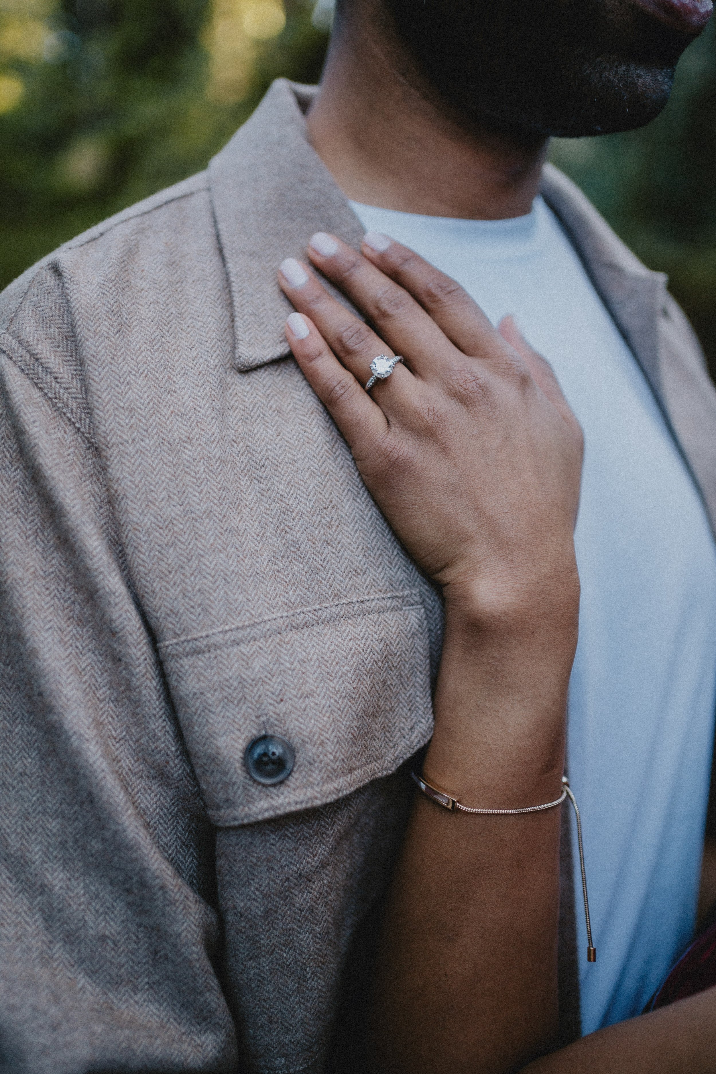 Engagement photography detail shot of couple’s hands during intimate outdoor session in Portugal.