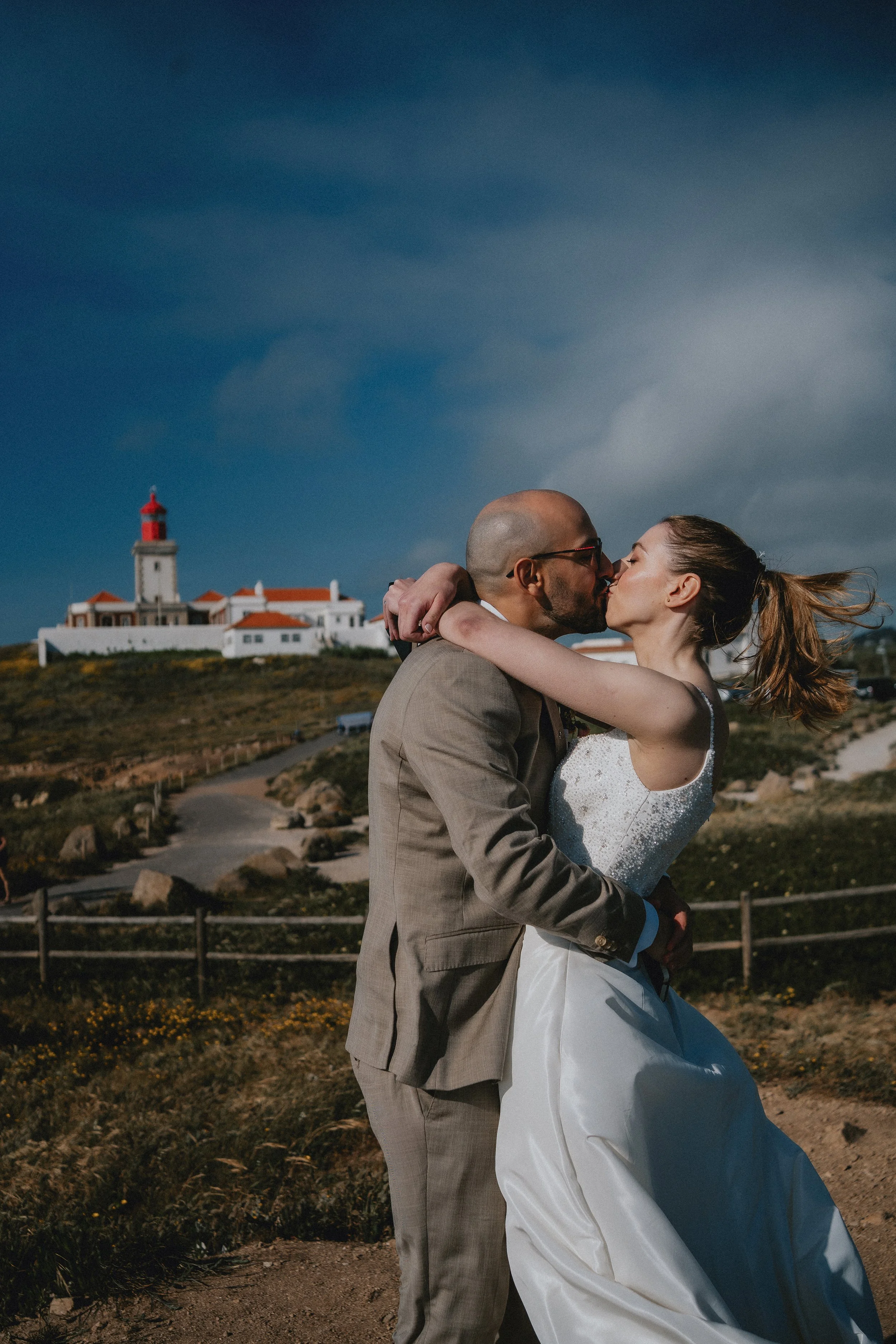 Emotional embrace during intimate wedding in Portugal at sunset
