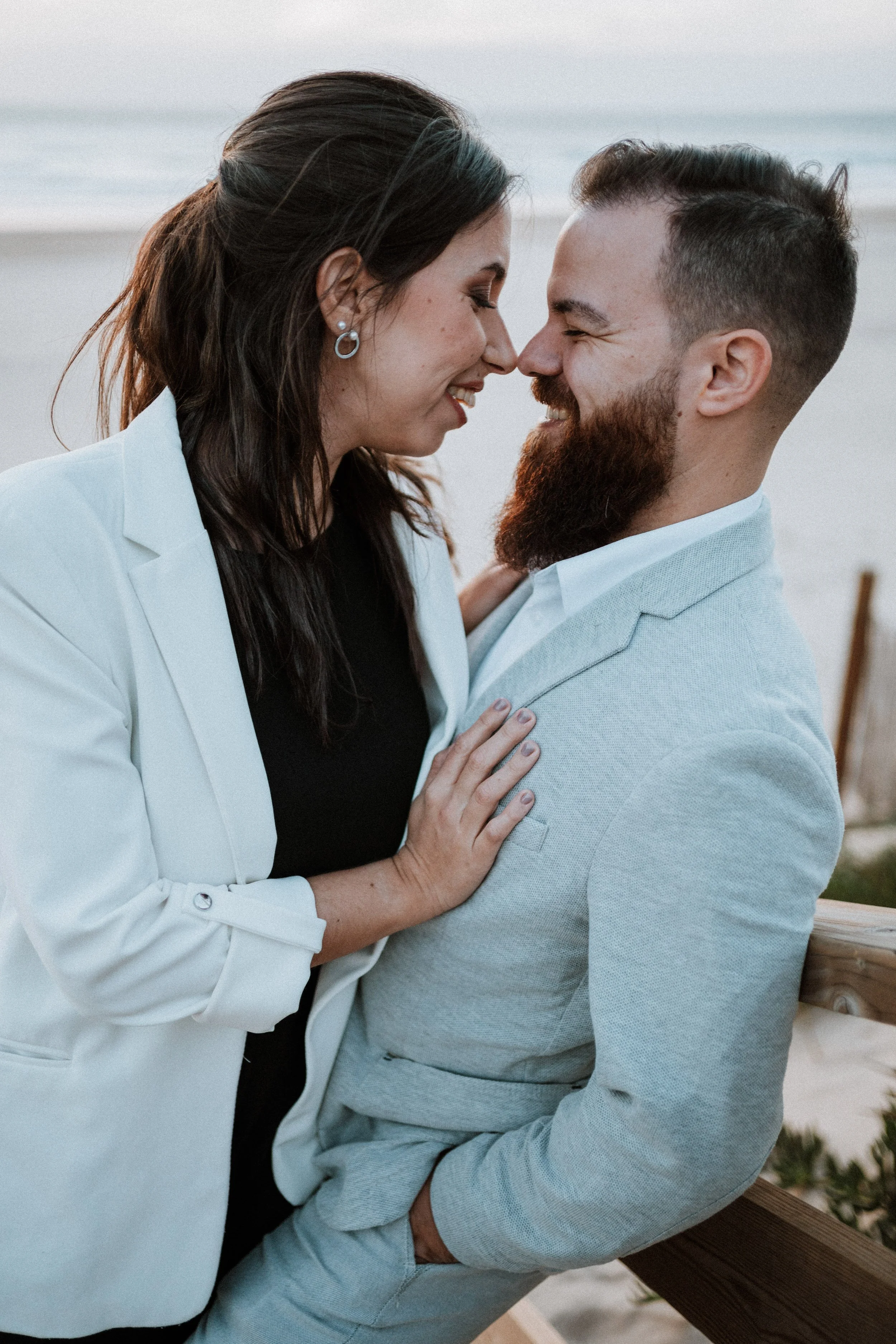 Romantic engagement photography in Portugal, couple holding each other during outdoor session.