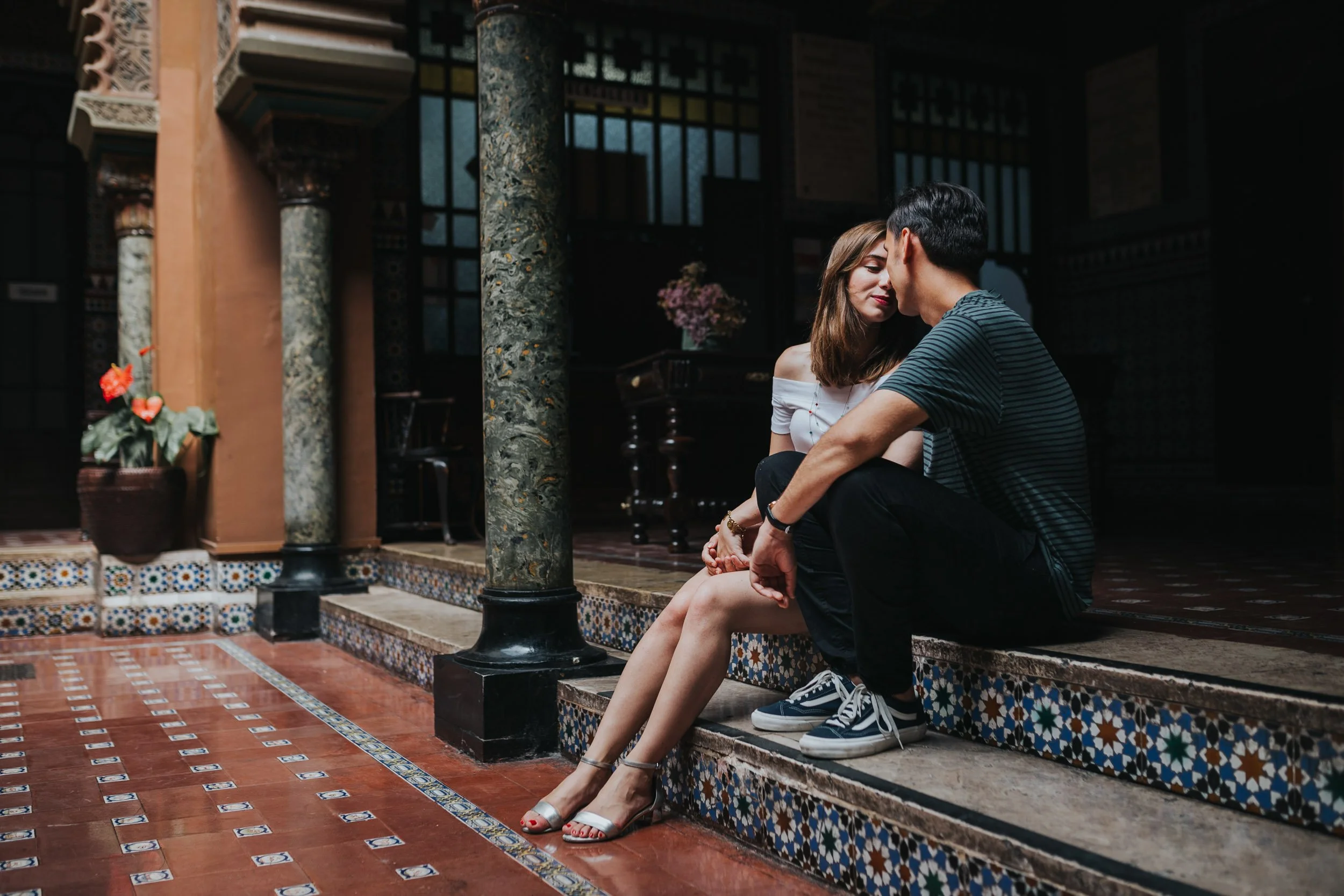 Engagement photography in Lisbon, couple sitting together on historic tiled steps.