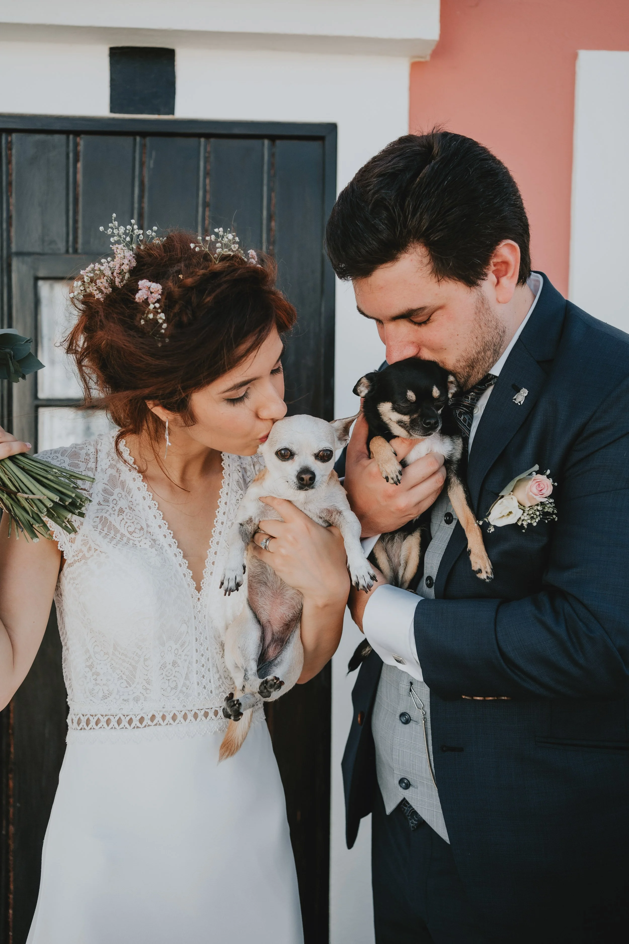 Bride and groom holding their dogs during intimate wedding in Portugal – pet-friendly wedding photography by Wandersoul Stories.