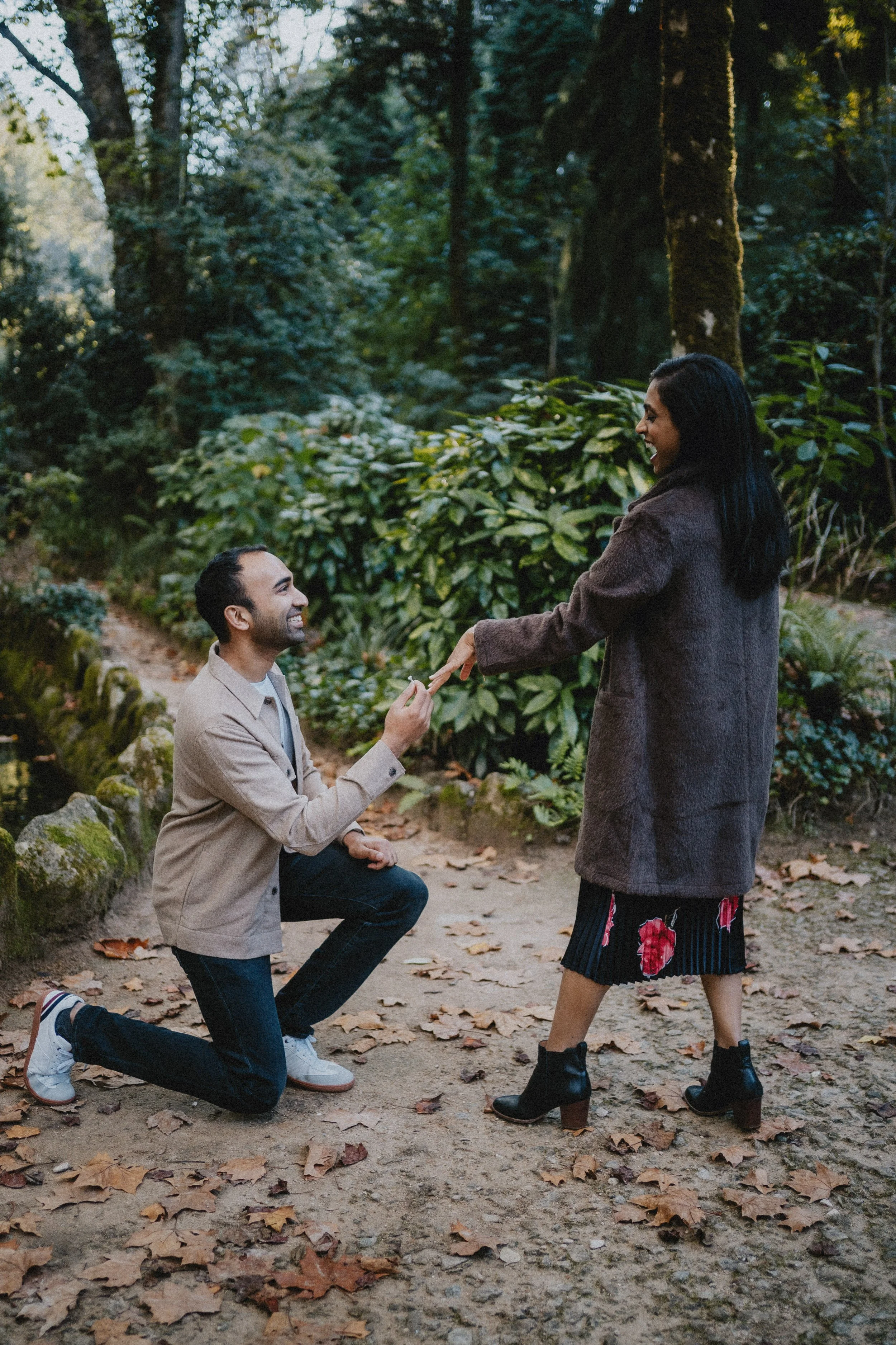 Candid engagement photography in Portugal, couple sharing quiet moment in natural outdoor setting.