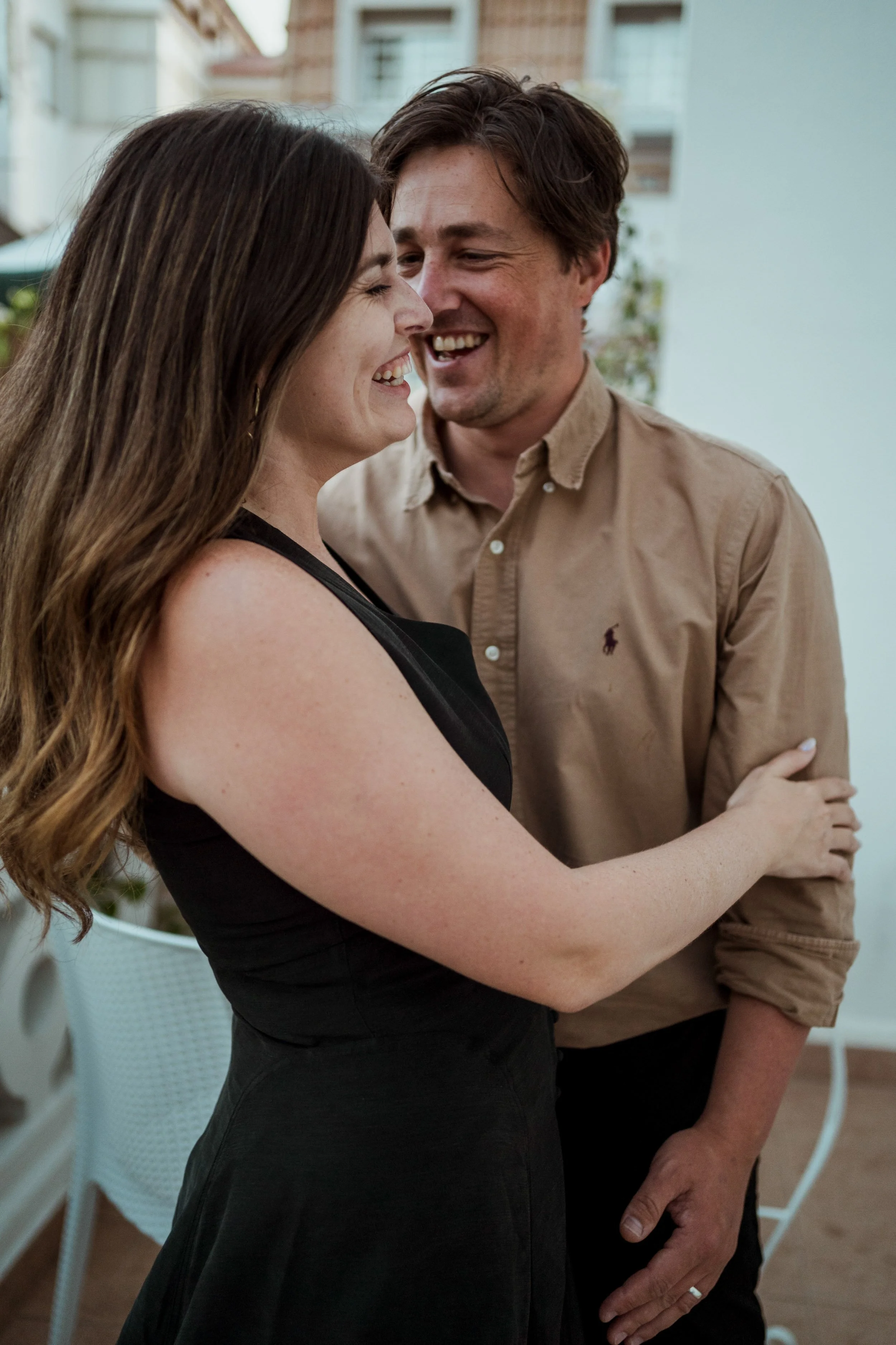 Romantic engagement photography in Portugal, couple holding each other during outdoor session.