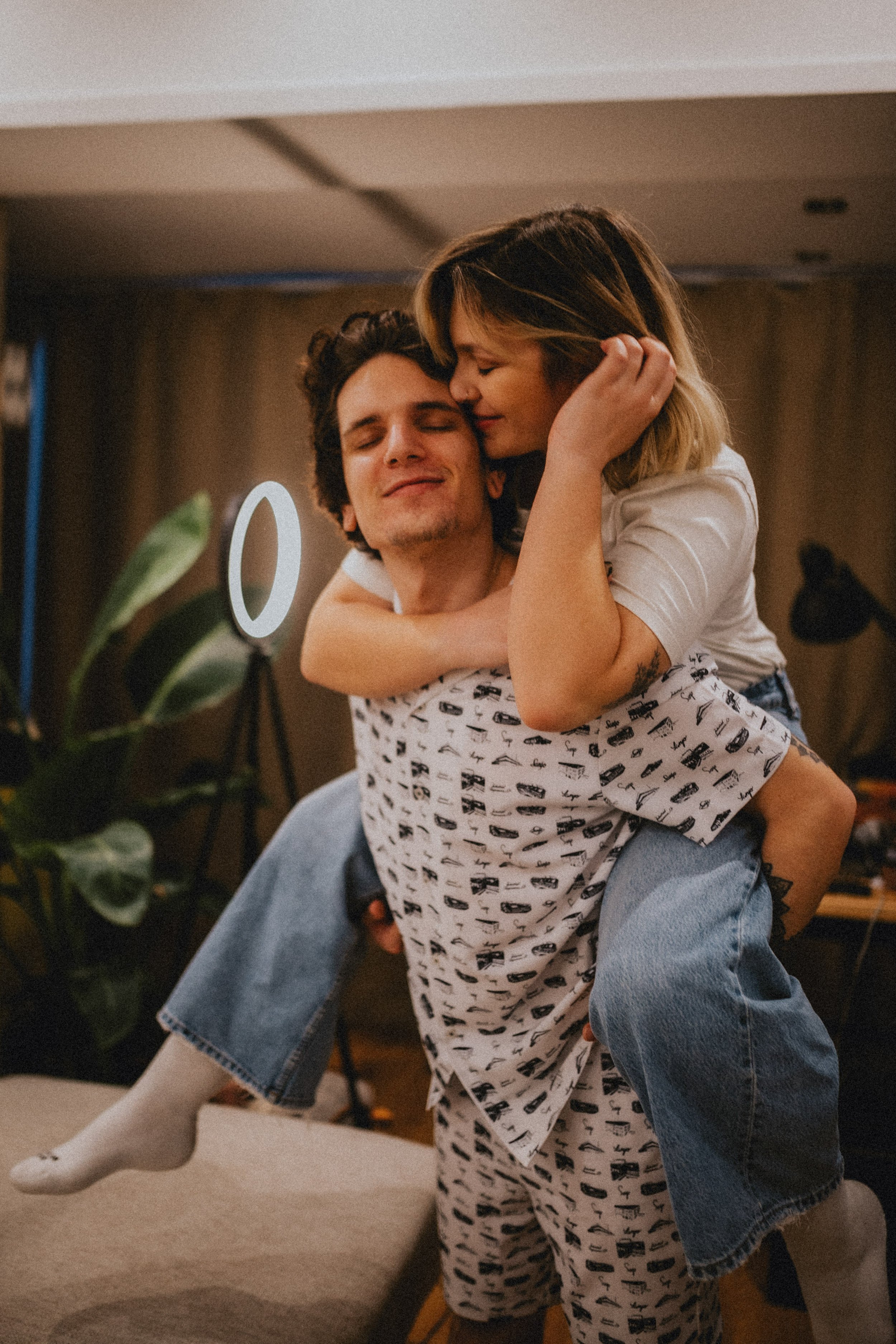 Alternative engagement photography indoors in Lisbon, hugging romantically.