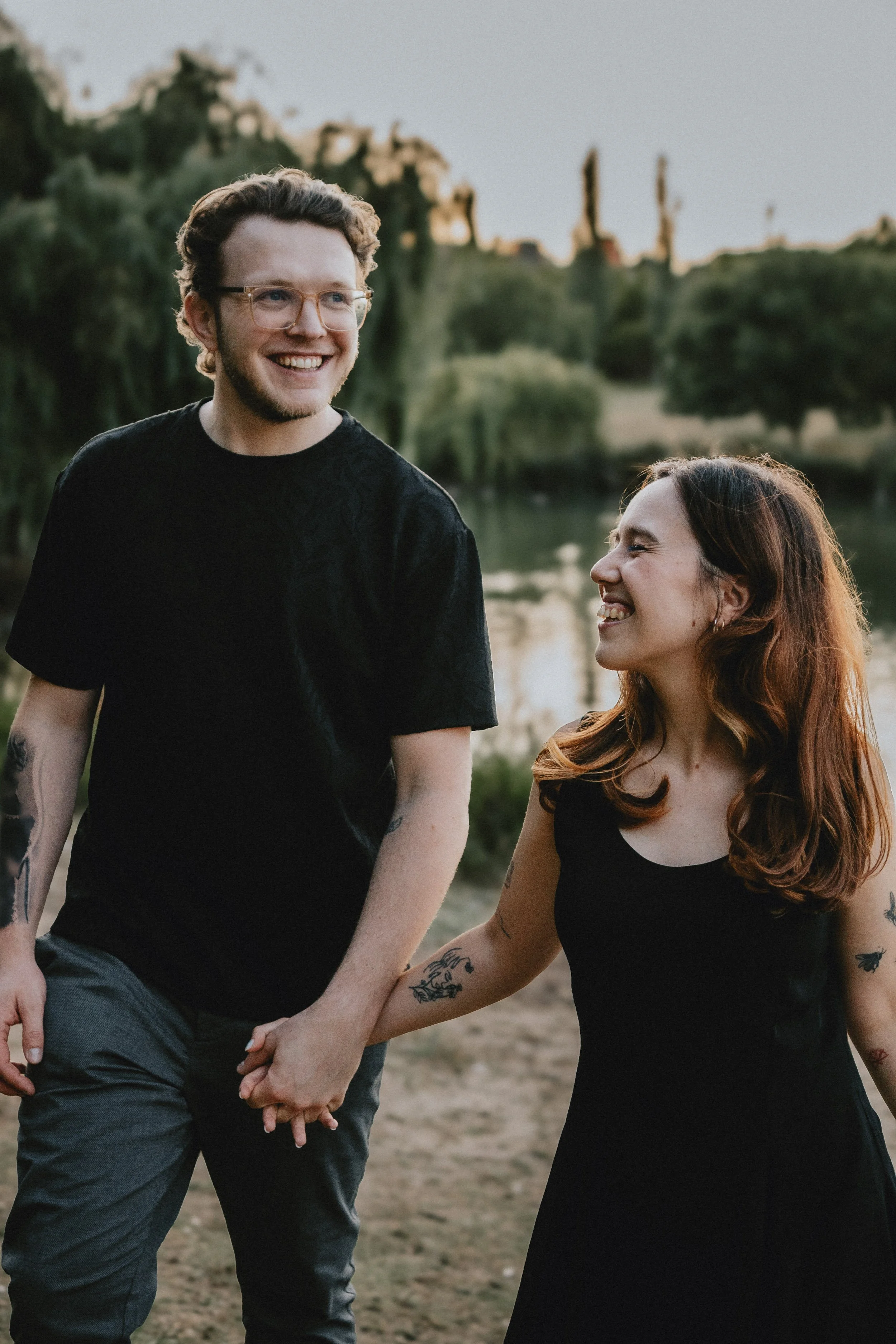 Candid engagement photography in Portugal, couple laughing together during relaxed outdoor session.