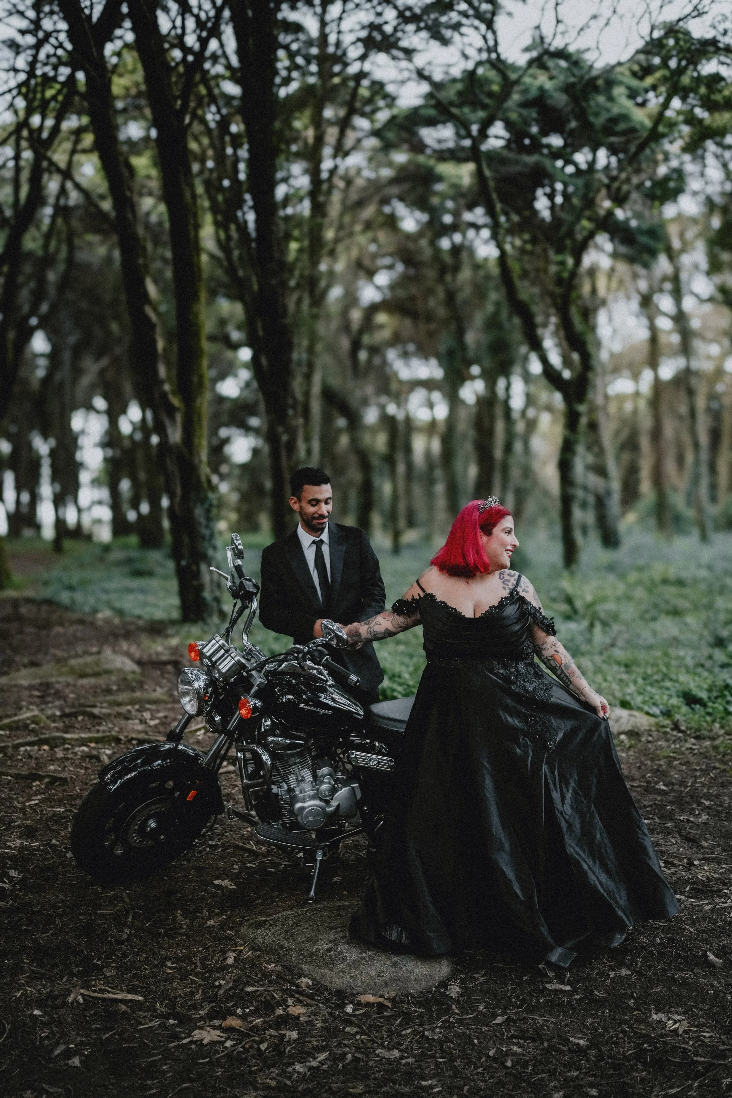 Alternative wedding couple in forest with motorcycle during cinematic destination wedding in Portugal