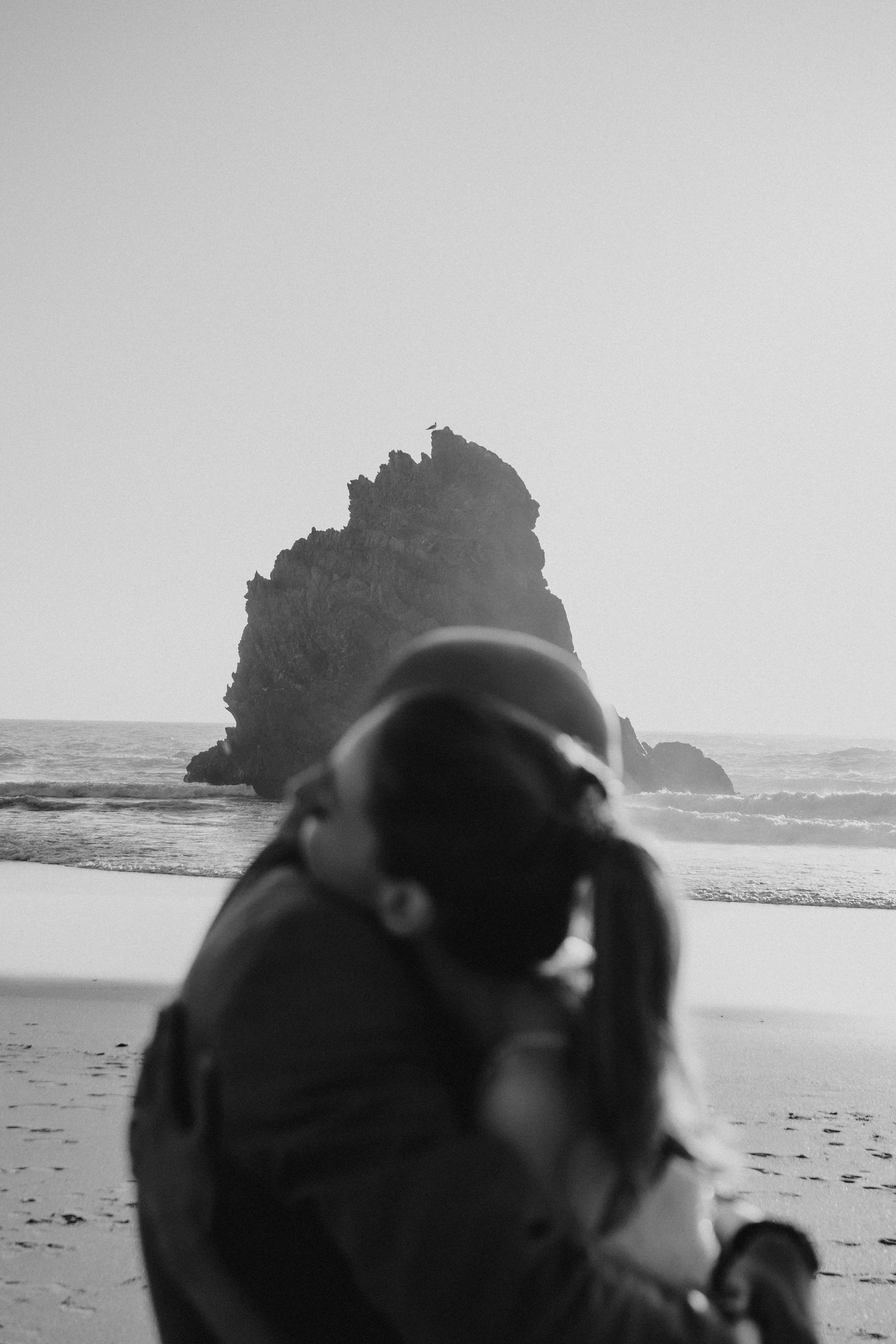 Intimate beach elopement in Portugal with couple embracing near dramatic ocean cliffs at sunset