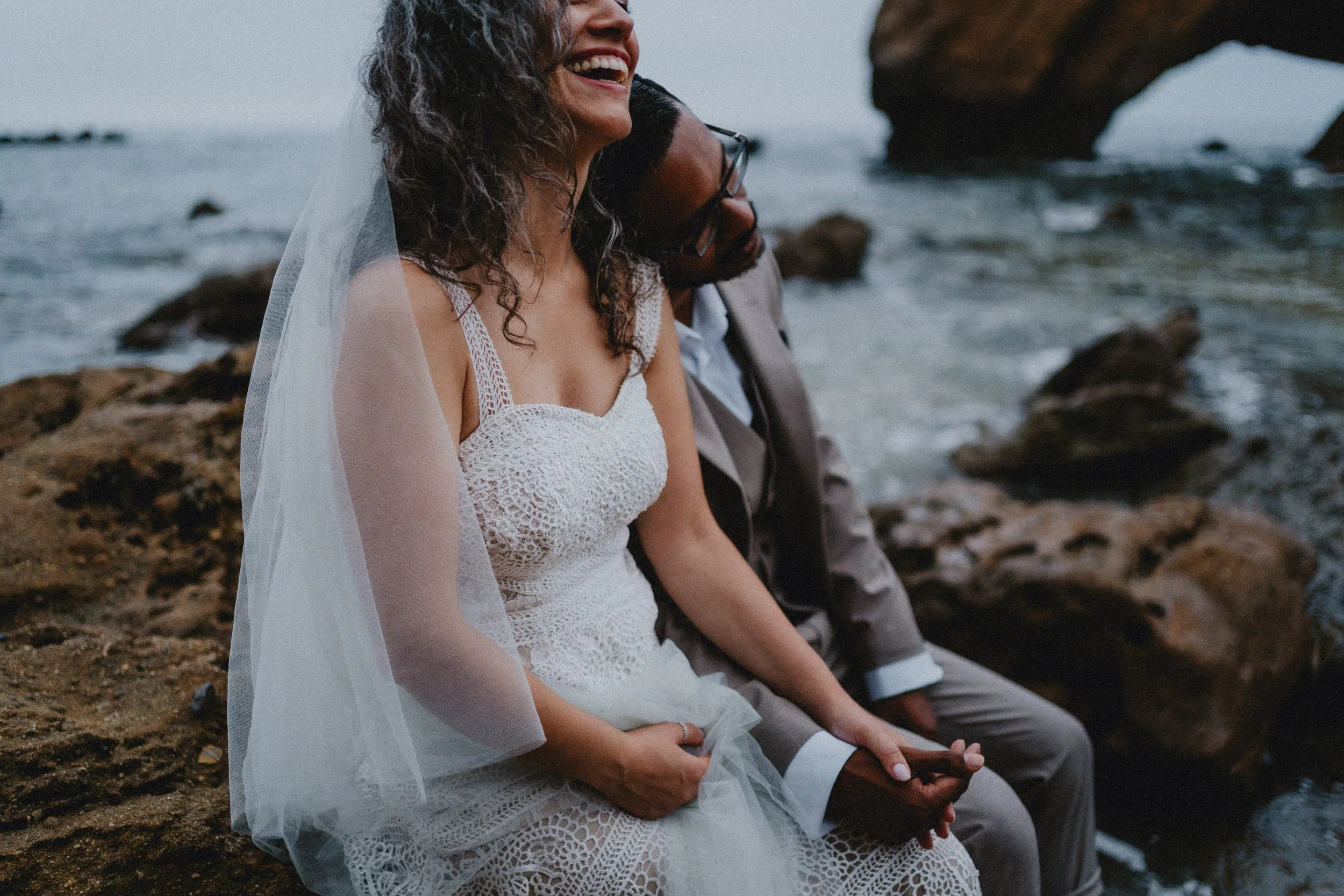 Close-up bridal detail highlighting lace wedding dress texture in natural light
