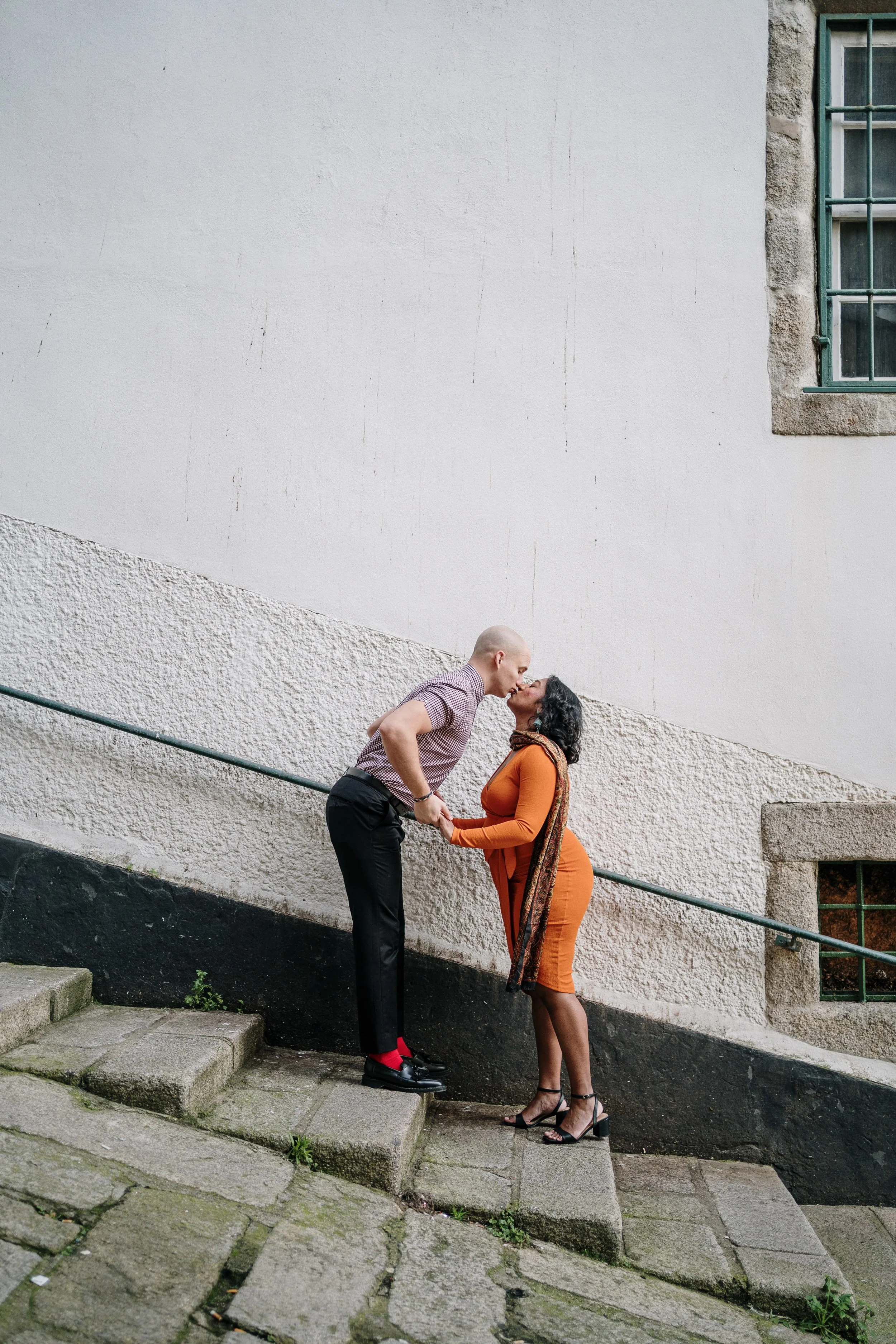Urban maternity photoshoot in Portugal capturing couple embracing during pregnancy session.