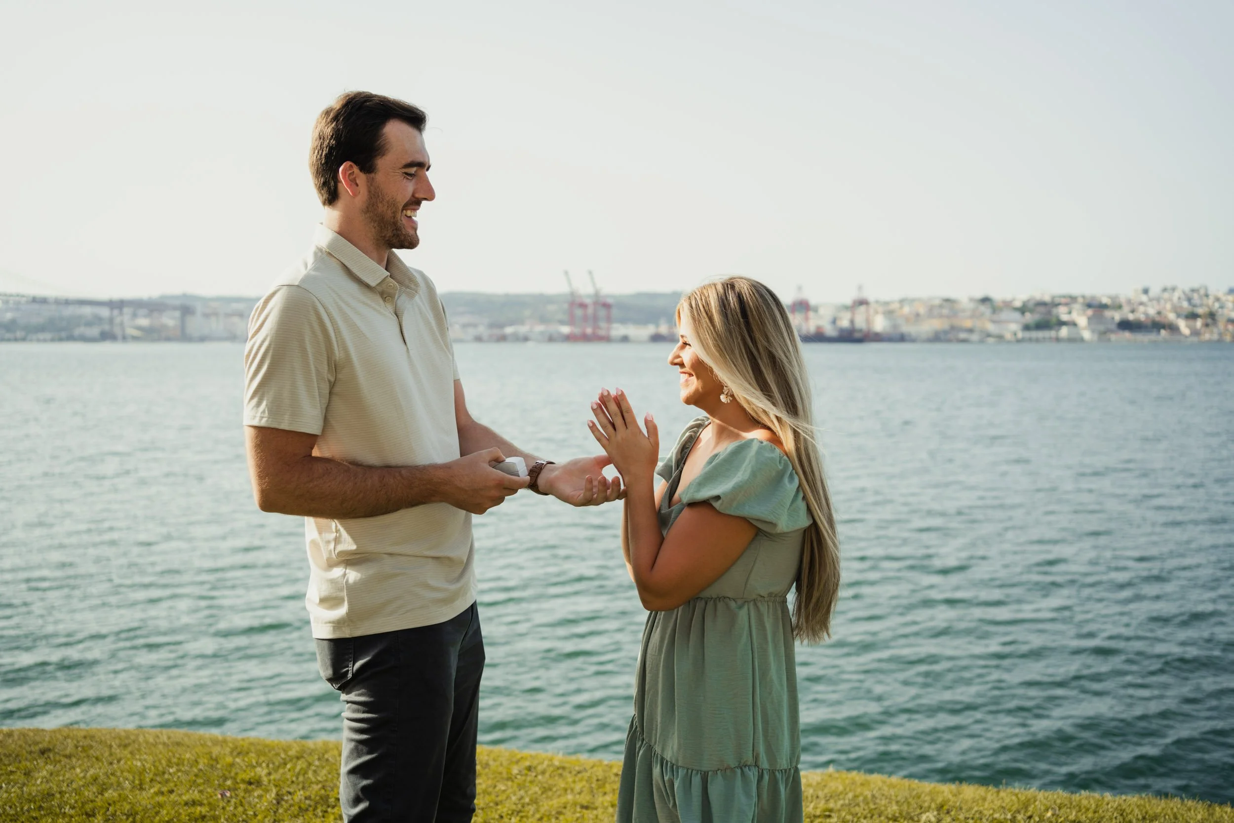 Engagement photography in Portugal, couple talking together near the water during outdoor session.