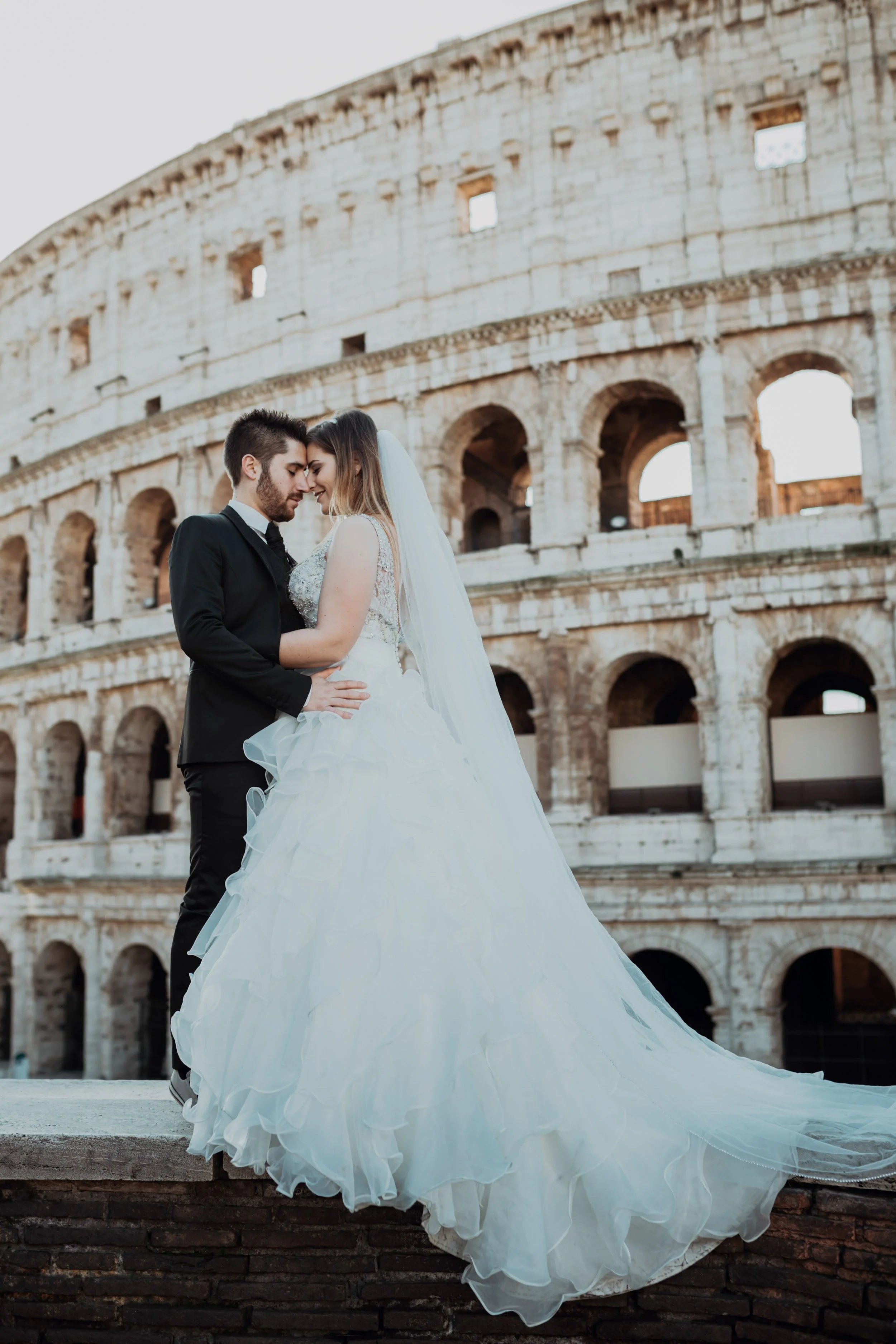 Romantic couple portrait in front of the Colosseum in Rome – European destination wedding photography by Wandersoul Stories.