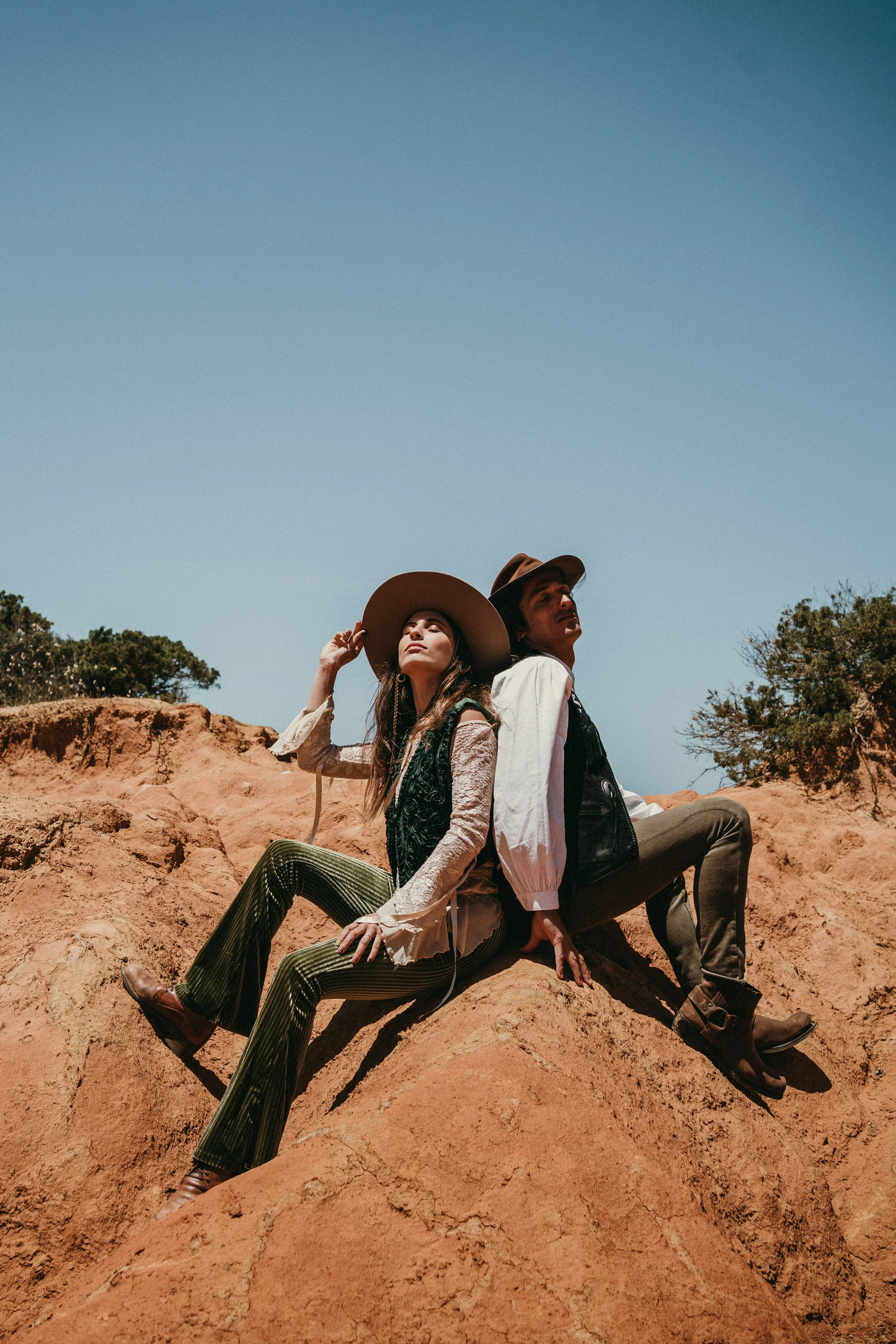 Romantic couple sitting on coastal cliffs during intimate elopement in Portugal