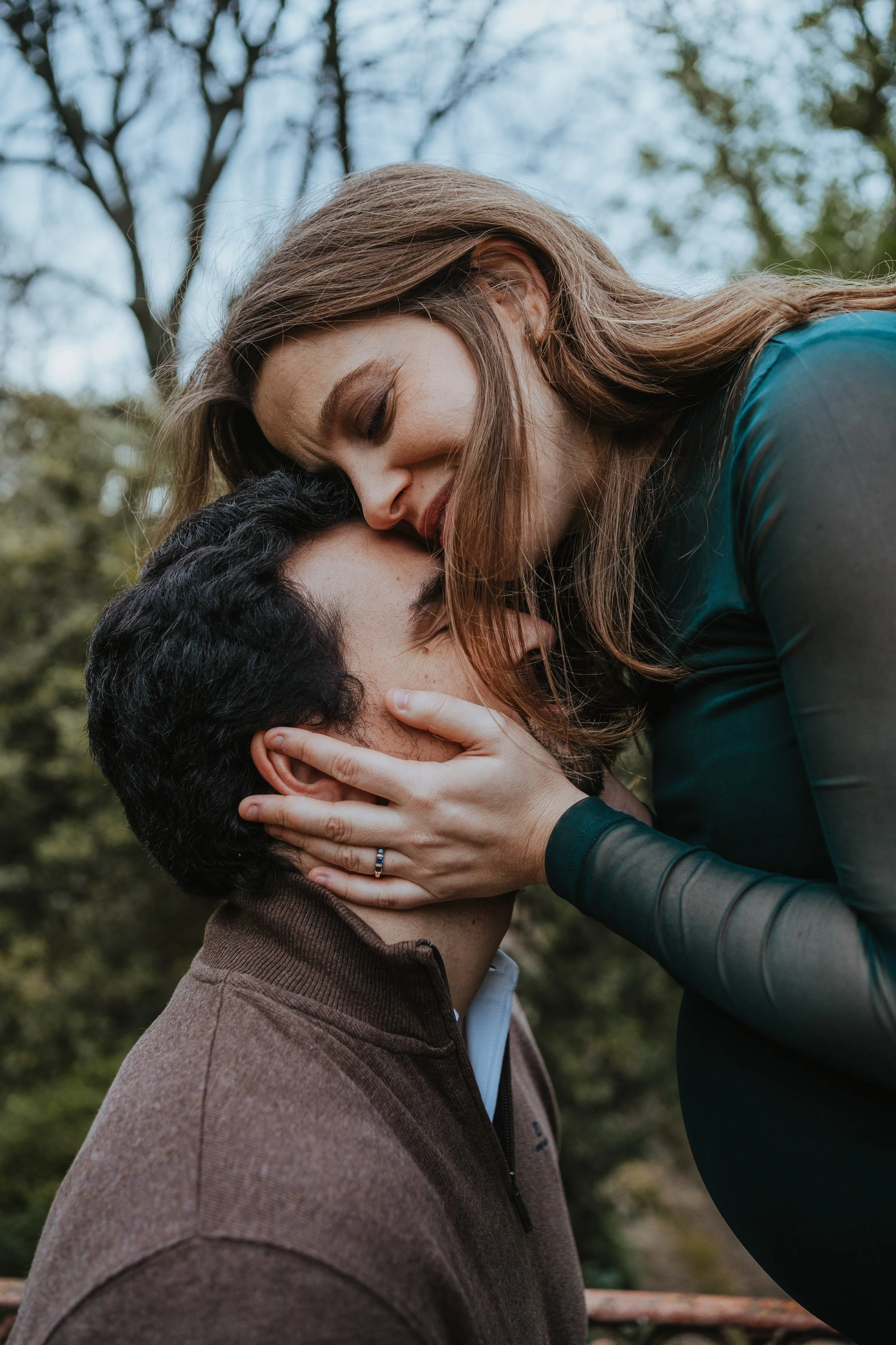 Engagement photography in Portugal, couple sharing intimate kiss during natural outdoor session.