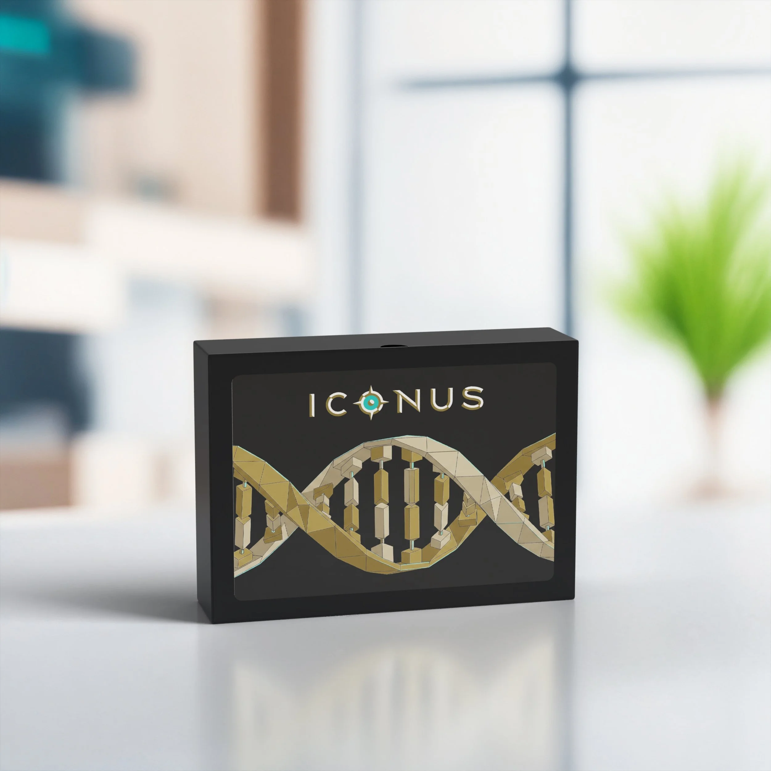 Close-up of a black box with the word 'ICONUS' on it, featuring a geometric design of an animal, possibly a fox or a wolf, made of interconnected gold-colored segments, against a blurred background with a window and some green foliage.