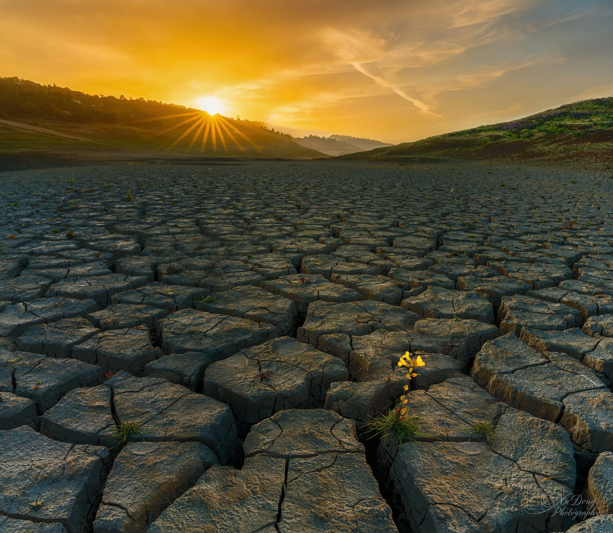 A panoramic view of the parched, patterned earth at Anderson Reservoir.