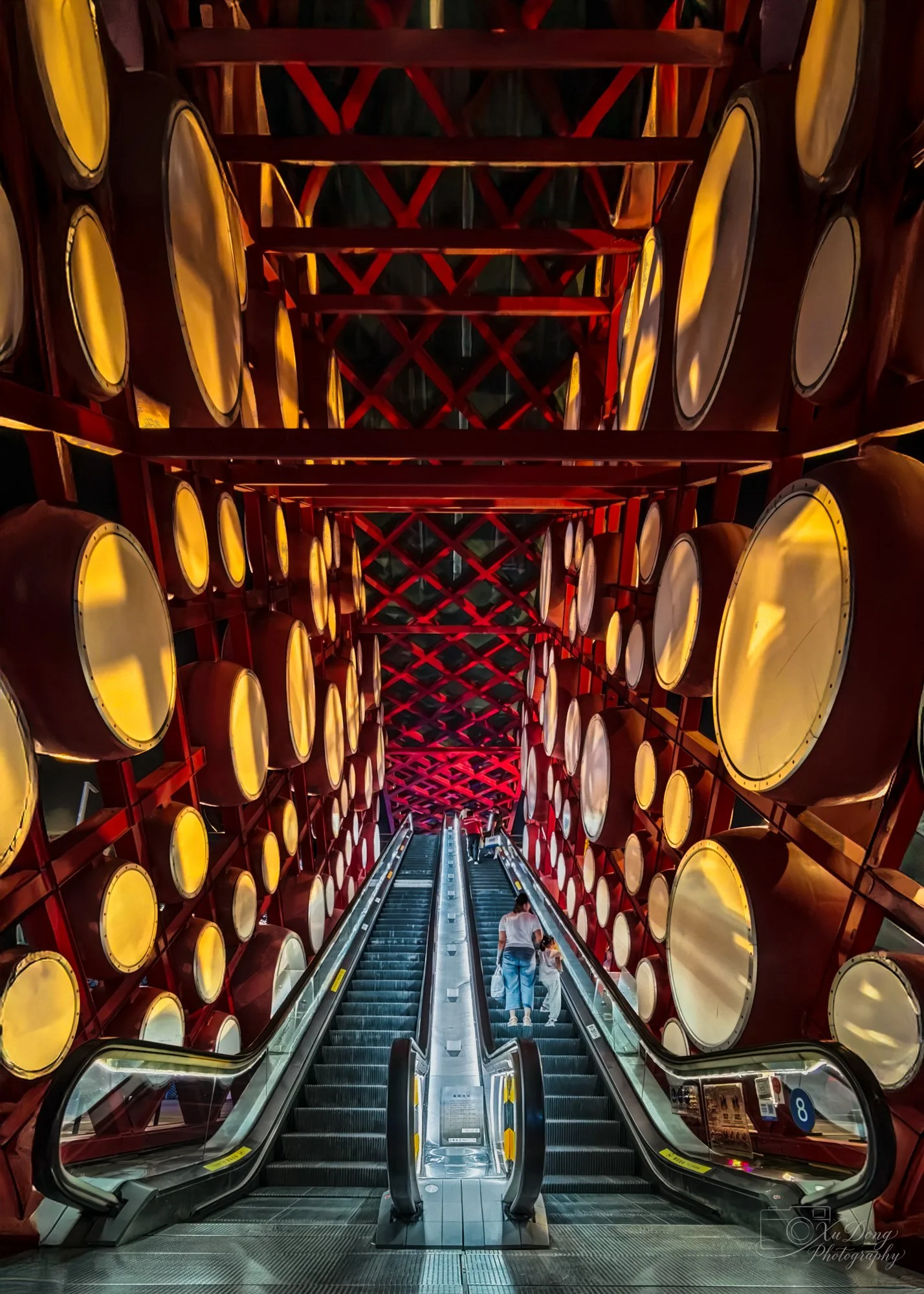 A cinematic capture of traditional Chinese drum-like architectural structures at night, featuring clean lines and a moody, atmospheric reflection.