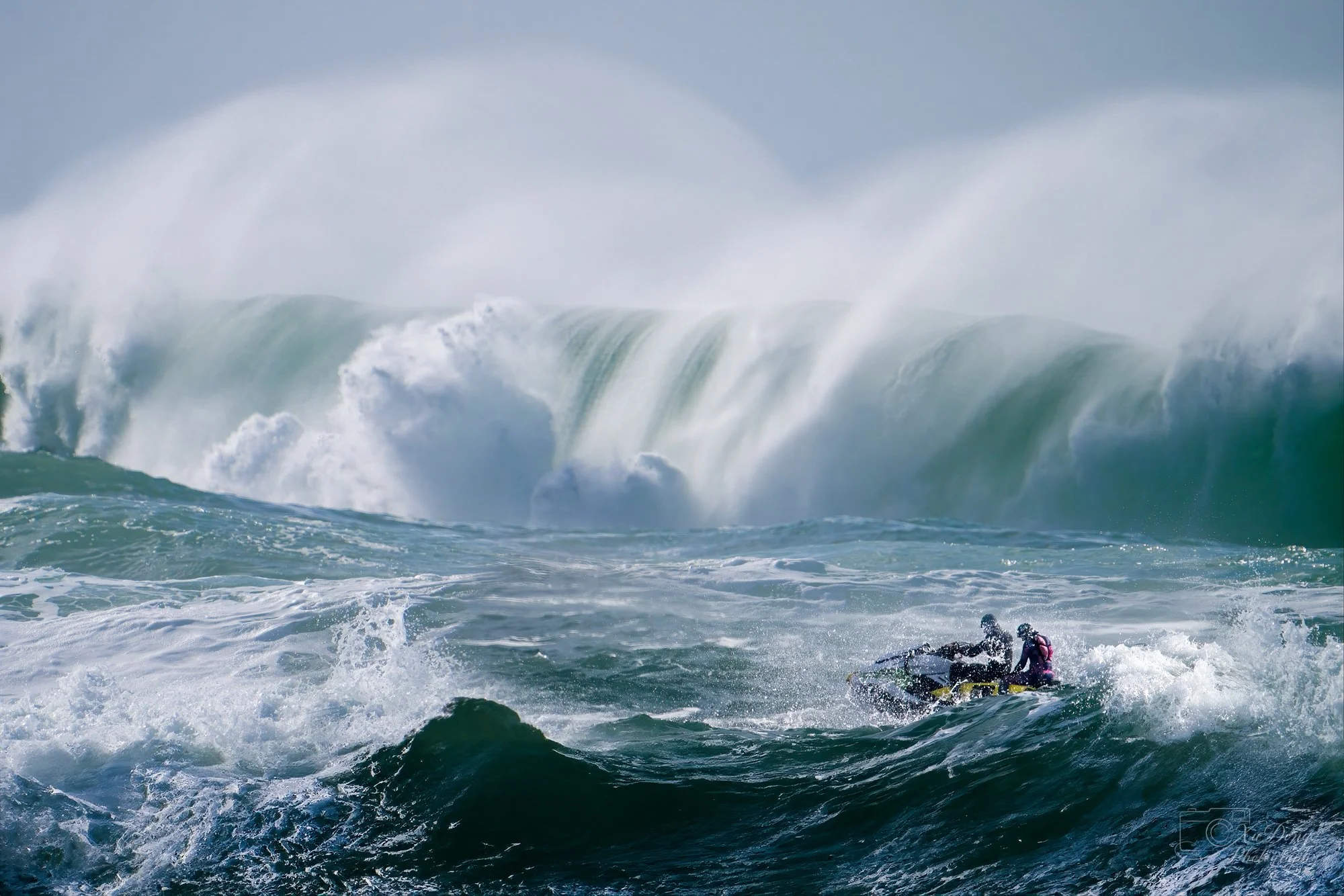 Adventure and coastal landscape photography, action shot of a jet ski navigating massive ocean swells