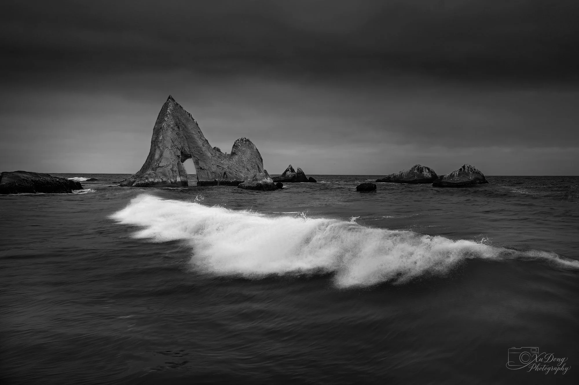 Aerial view of a rugged coastal sea arch